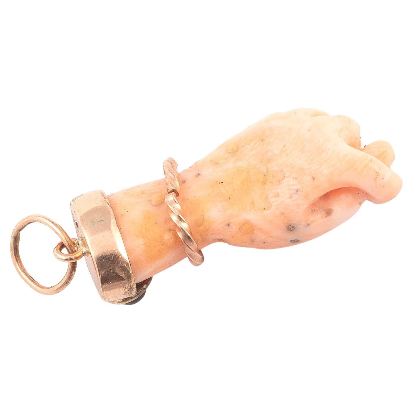 A beautiful figa hand charm made of *coral and set with a 14 karat gold bail. The hand is nicely detailed. The charm is great worn alone or layered with your other favorites. The charm comes without the necklace. 
The figa hand symbol dates back