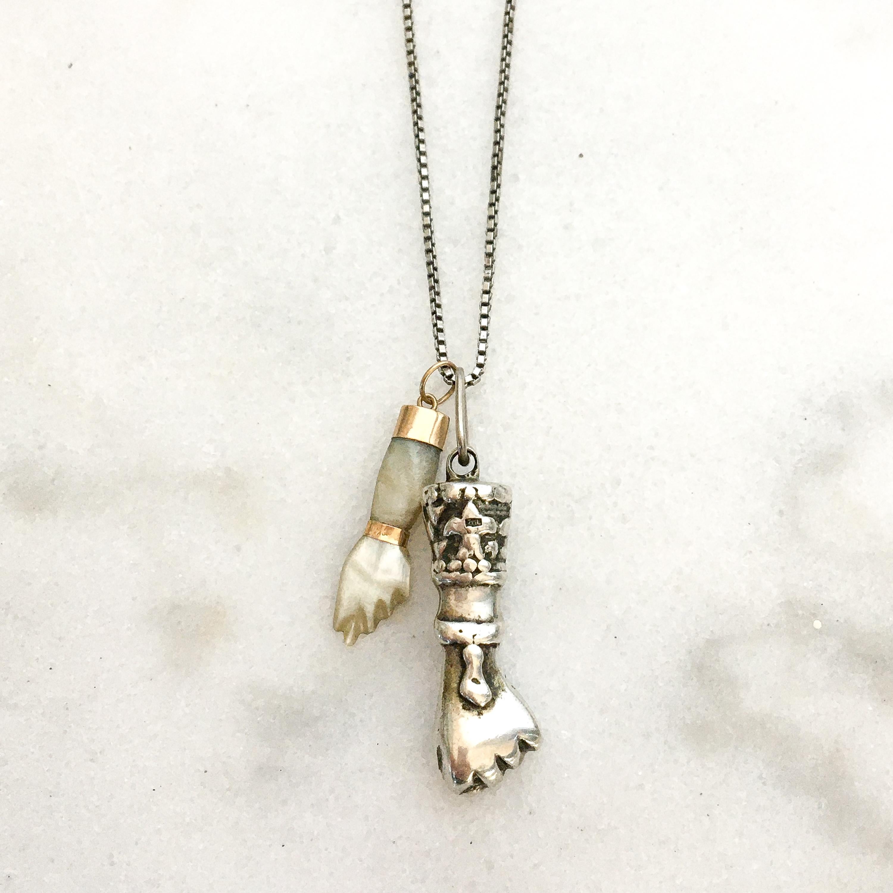 A vintage mid-century figa good luck charm crafted in solid silver. The figa has nicely engraved details with a fleur-de-lis on the front and back of the sleeve. The charm is great worn alone or layered with your other favorite beauties. The charm