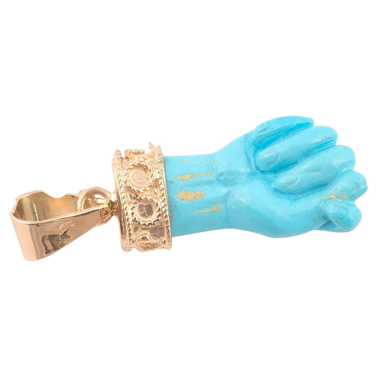 A beautiful figa hand charm made of Turquoise  and set with a 14 karat gold bail. The hand is nicely detailed. The charm is great worn alone or layered with your other favorites. The charm comes without the necklace. 
The figa hand symbol dates back
