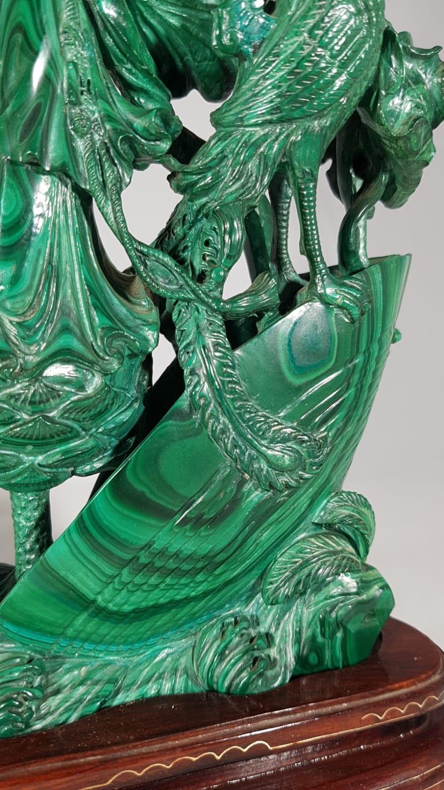 Green malachite female figure, China, late 19th/early 20th century sculpture, height 21.5 cm, length 19 cm, height with wooden base 25 cm. The wooden base is anatomical to the base of the sculpture and has inlays with brass wire to create an