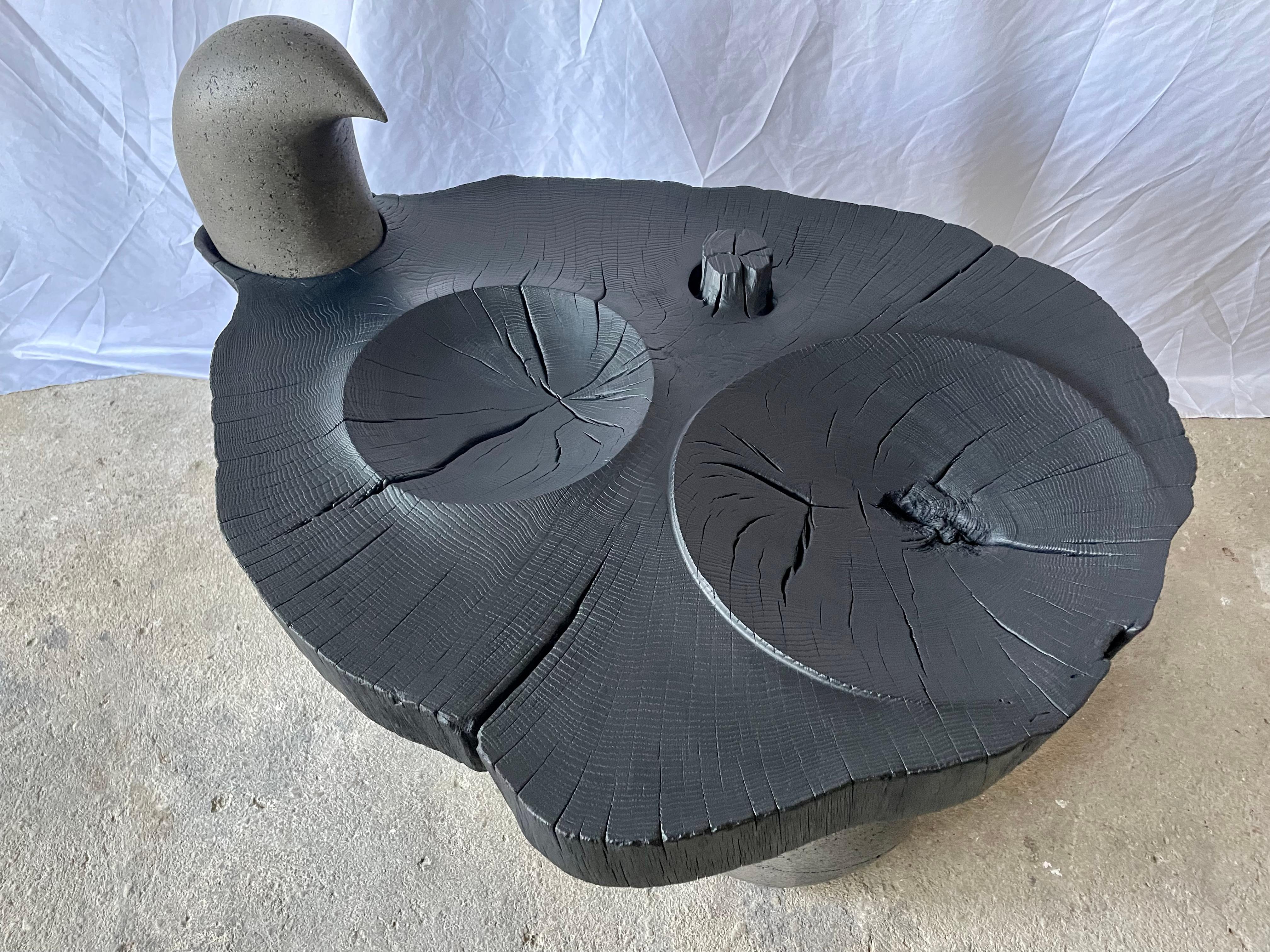 Figura Side Table by Christian Friedl
Unique Piece.
Dimensions: D 73 x W 98 x H 65 cm.
Materials: Oak, concrete.

I`m an eye-catcher of a special kind.
The oak tree I come from fell over in 2017 during a storm in Styria.
My creator saved me and