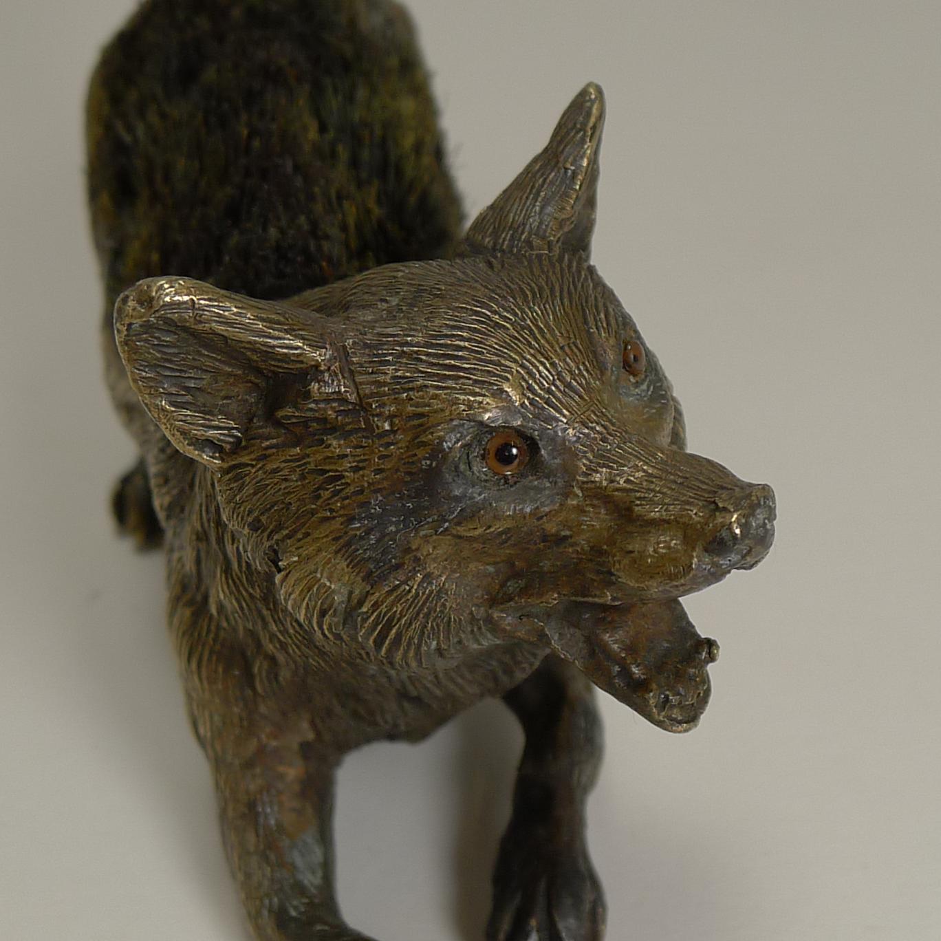 A fabulous novelty pen / nib wipe cast in bronze as a running Fox, beautifully executed and sporting his two glass eyes.

The underside is stamped twice 