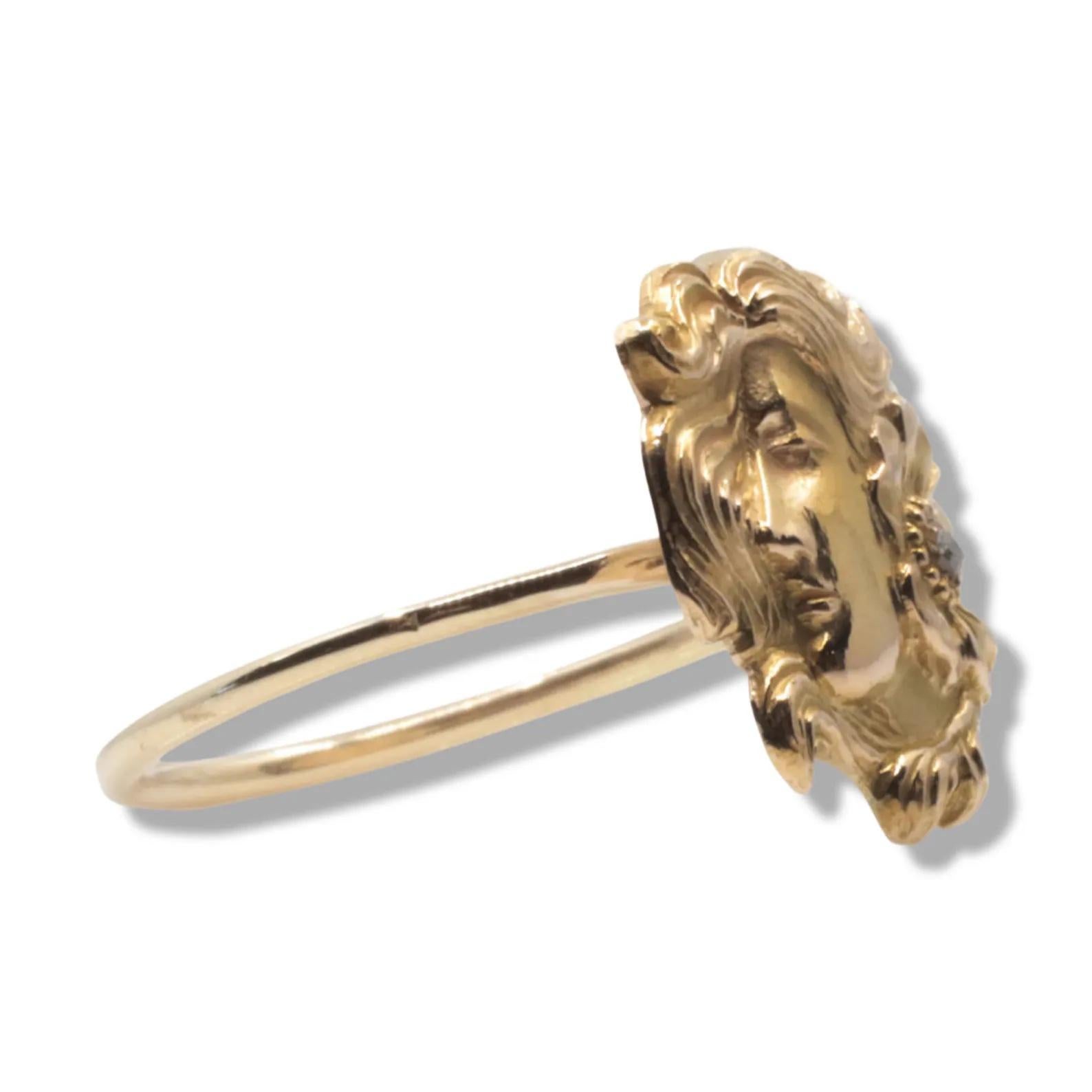 A beautiful handmade art nouveau period figural ring in 14 karat yellow gold. Accented by a single old mine cut diamond in a blossoming flower, this ring features the profile of a beautiful woman with flowing gold hair.

In excellent condition this