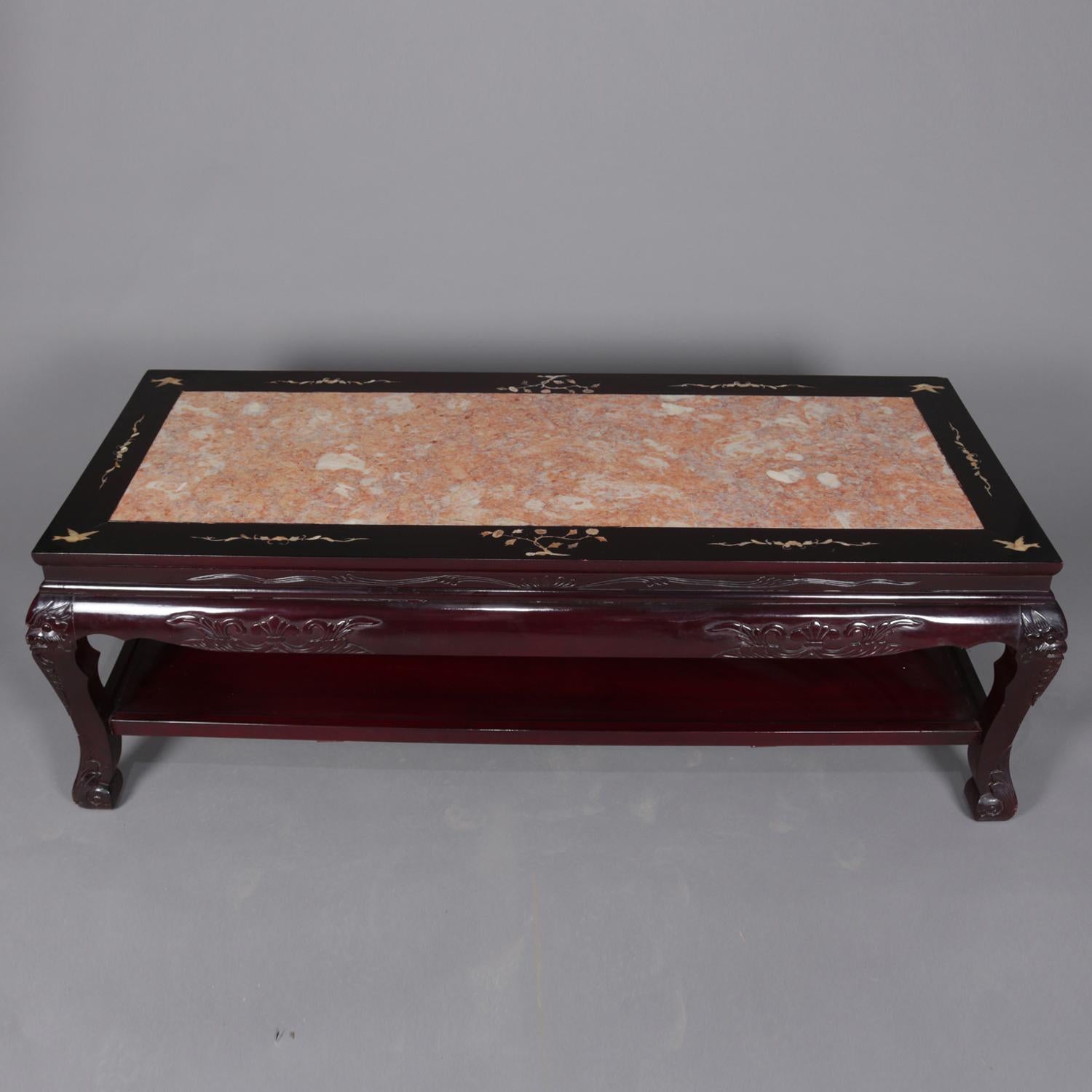 A pair of figural Chinese coffee table features inset marble top with mother of pearl inlay featuring bonsai and foliate elements surmounting hardwood base having carved foliate skirt and raised on legs with figural bird head masks and acanthus