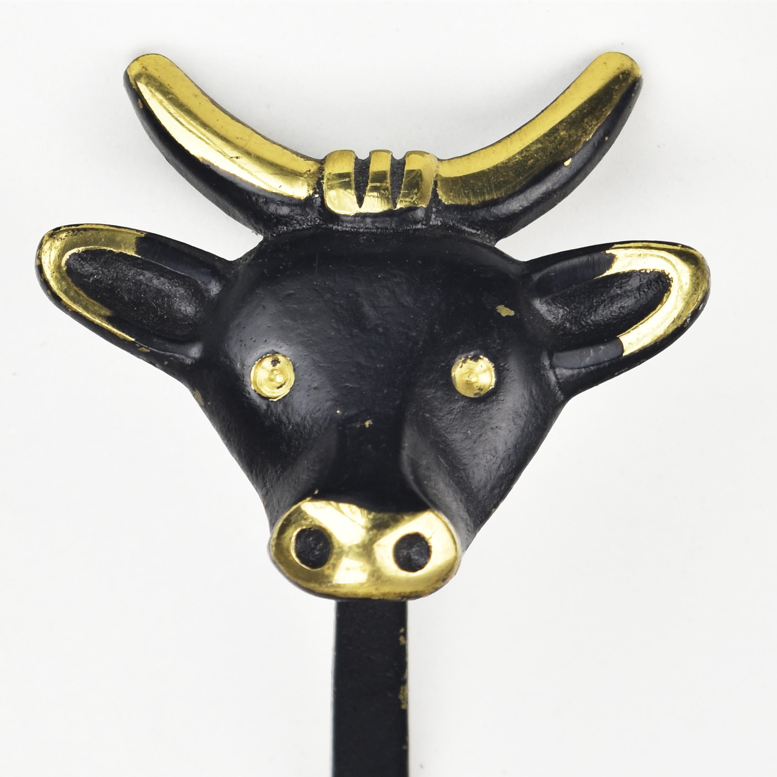 Iconic mid century modern black patinated brass or bronze figural cow or bull coat hook, designed by Walter Bosse for Herta Baller in the 1950s/60s.