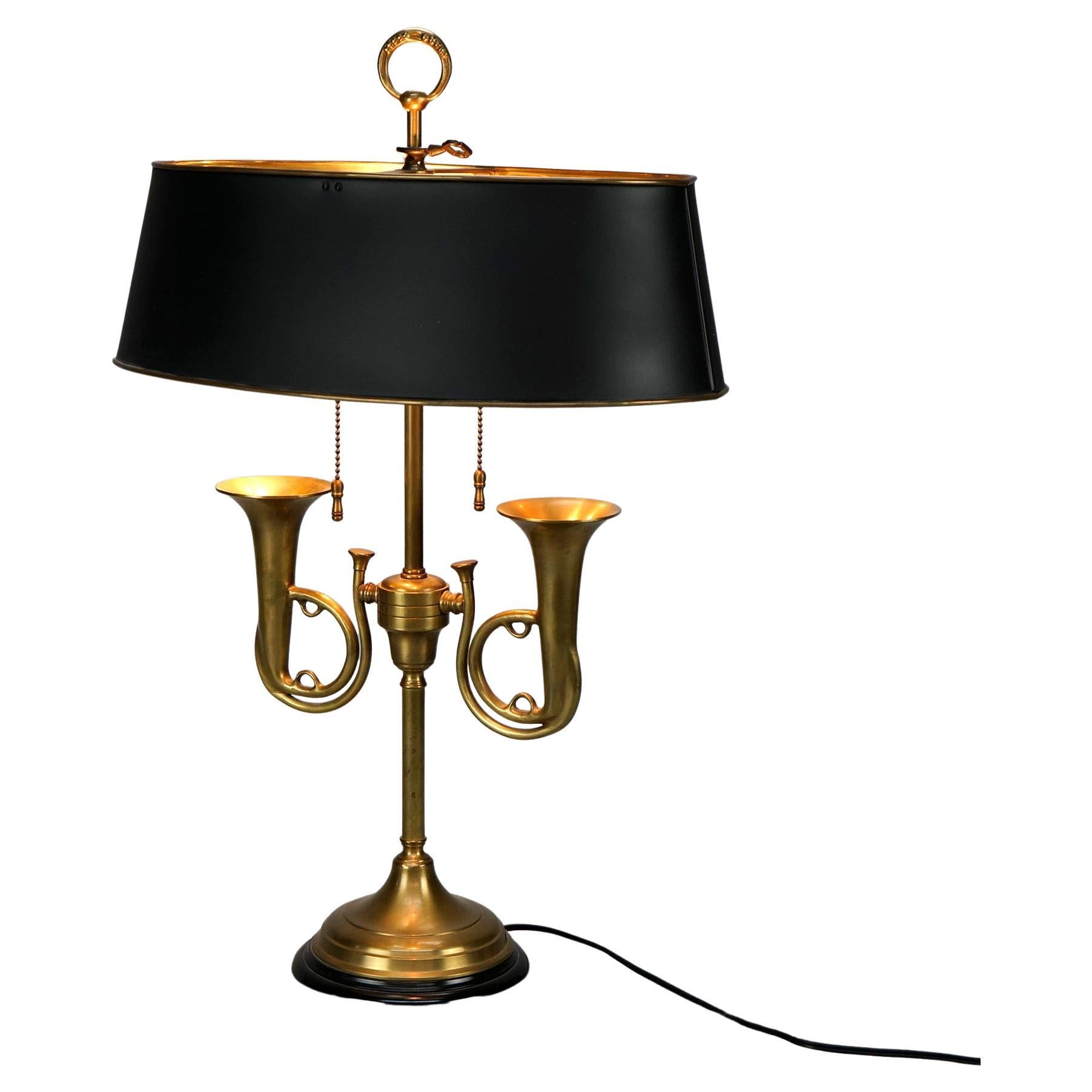 A figural Empire style Bouillotte desk lamp offers double socket brass base with French horns, 20th century

Measures- 25''H x 17''W x 10.25''D.