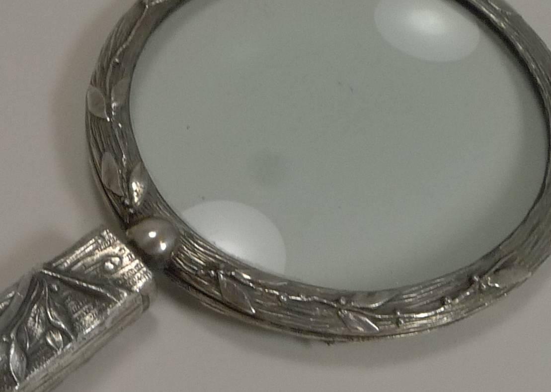 A most unusual and highly decorative magnifying glass made from silver plate and probably continental (perhaps French) in origin.

The heavy metallic handle is modelled in the form of a racing horse's head and then decorated with stylized foliage