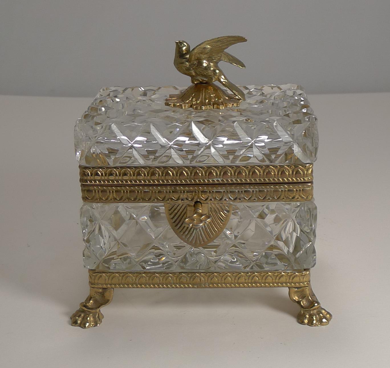 A very fine heavy crystal box deeply cut with ormolu mounts including Lion's paw feet and the most charming dove finial to the top.

The box is French dating to the early 20th century circa 1900 and comes complete with a working key.

As good as