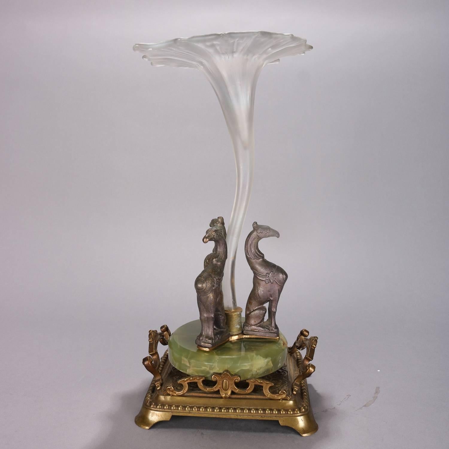 Antique French Victorian figural orchid epergne features gilt and footed base with three griffon sculptures seated atop onyx and supporting mouth blown iridized art glass tulip form vase, circa 1880

Measures: 14.5