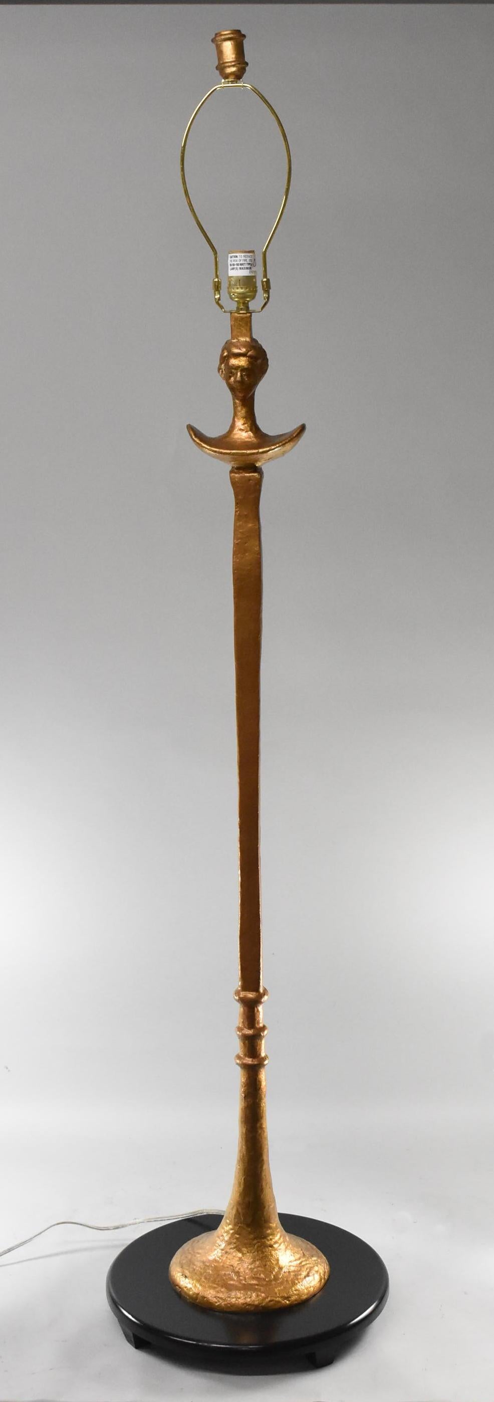 Figural gold cast iron floor lamp with single socket in the style of Alberto Giacometti. Shade is not included.
