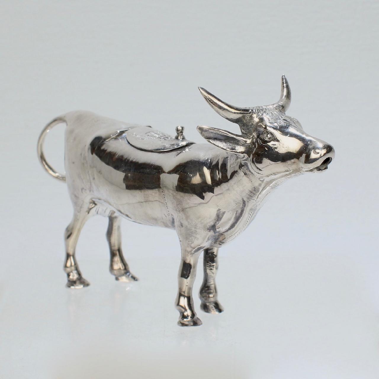 A very fine figural sterling silver creamer or milk pot by Israel Freeman & Son.

In the form of a cow with a loop 'tail' handle, hinged lid to the back, and spout at the mouth.

A truly whimsical creamer perfect for any breakfast
