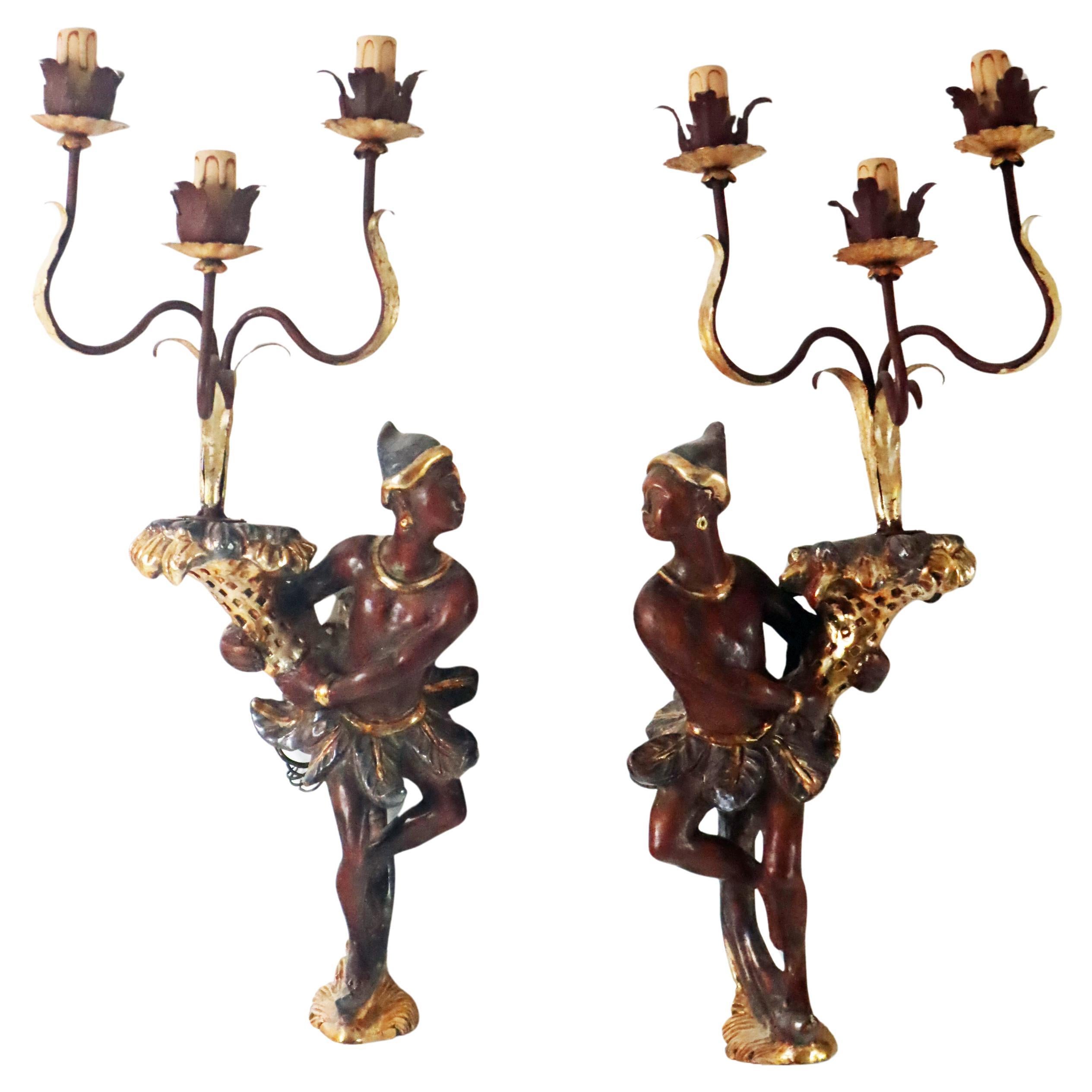Take a look at this unique, masterful pair of wall lights. These wall lights were purchased for a stately home in the 1950s and imported from Italy. See for yourself how the wood was worked with artistic skill by a master craftsman and painted to