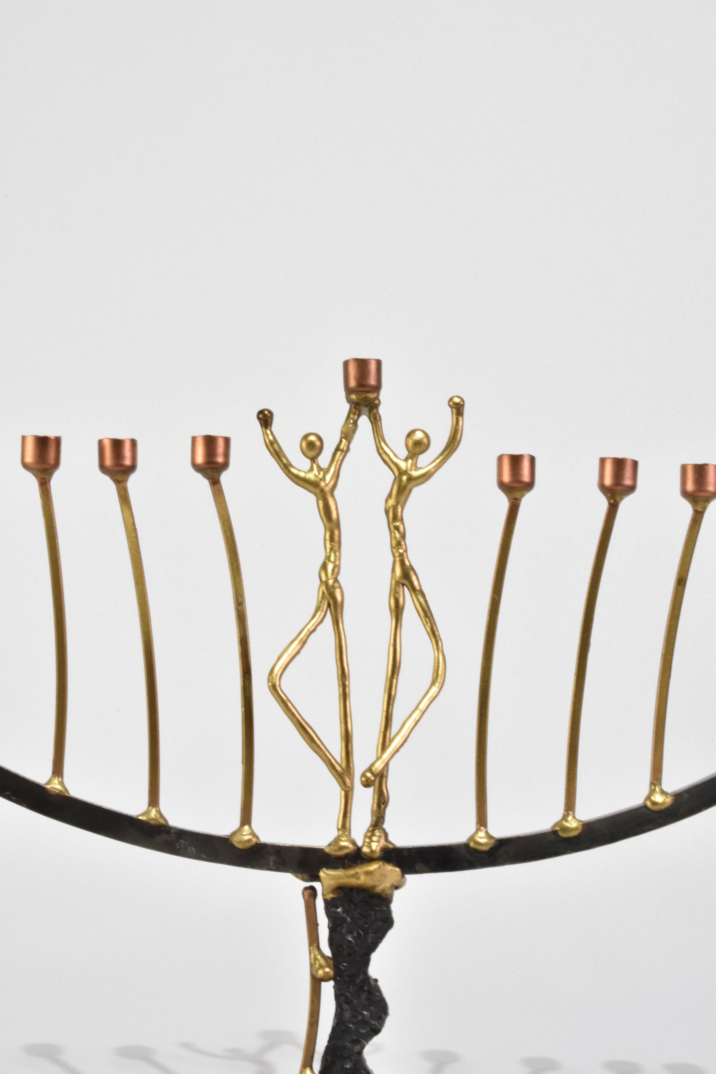 One-of-a-kind vintage handmade menorah in brass and copper with two figures supporting the shamash.
