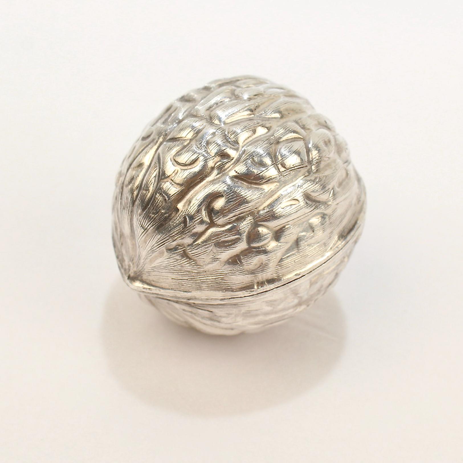 Eine tolle figurale Pillendose aus Sterlingsilber. 

In Form einer Walnuss. 

Mit medialem Gelenk und Twist-Lock-Verschluss. 

Provenienz: 
Aus der Sammlung des legendären Innenarchitekten Mario Buatta. 
 
Datum: 
20. Jahrhundert

Gesamtzustand: 
Es