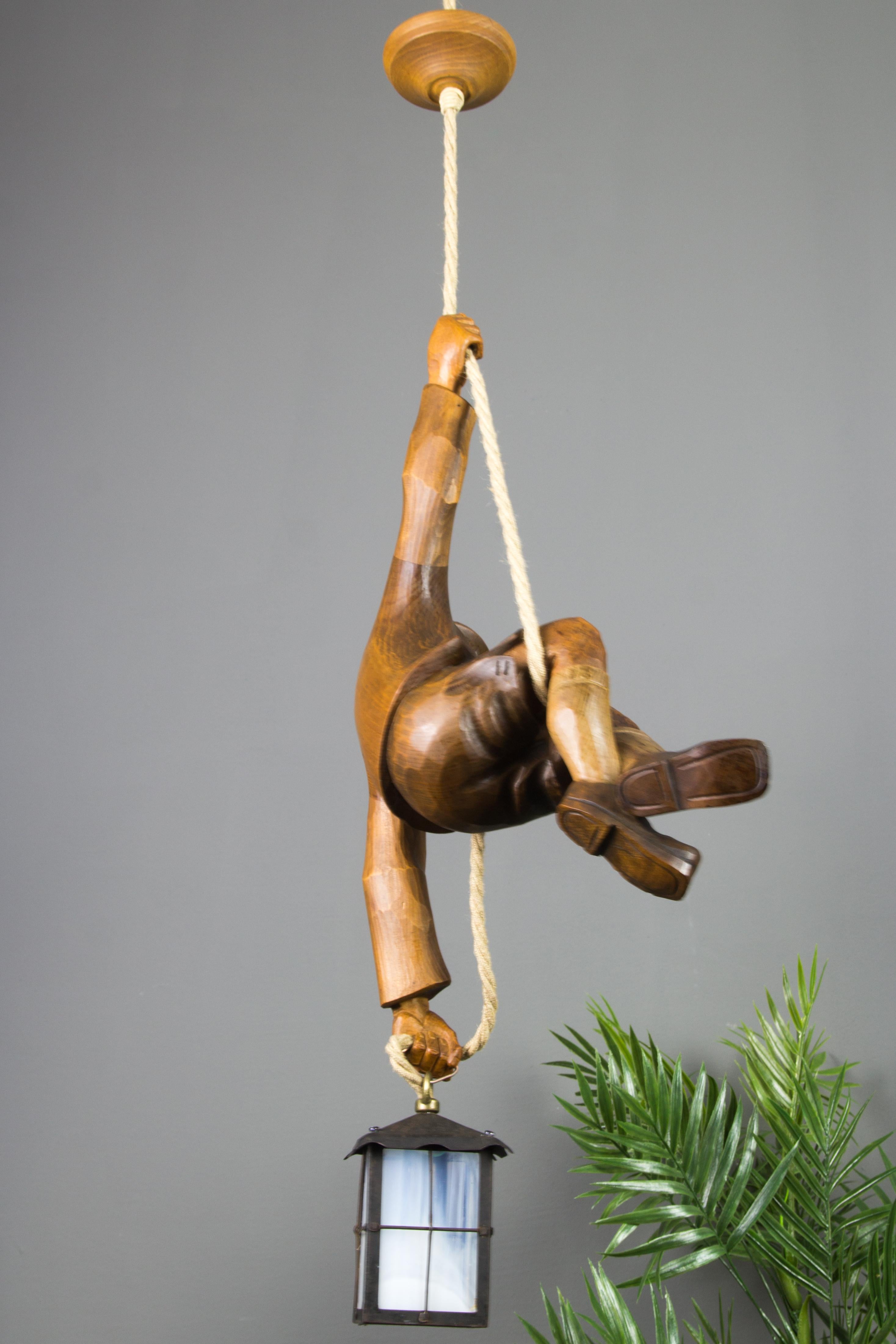 Hand-Carved Figural Pendant Light of a Hand Carved Wood Figure Mountain Climber with Lantern