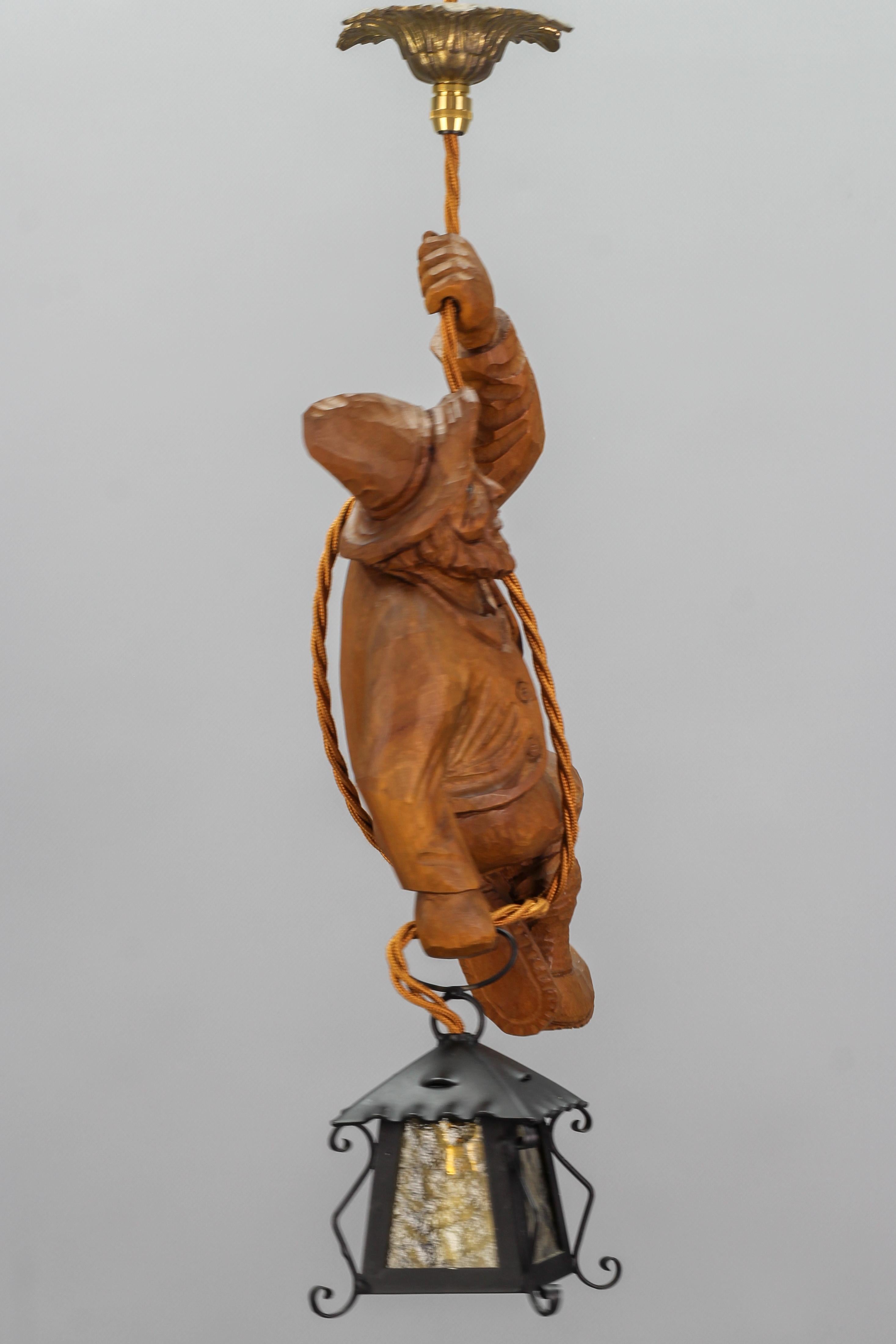 Hand-Carved Figural Pendant Light with a Carved Mountain Climber Figure and Lantern, Germany For Sale