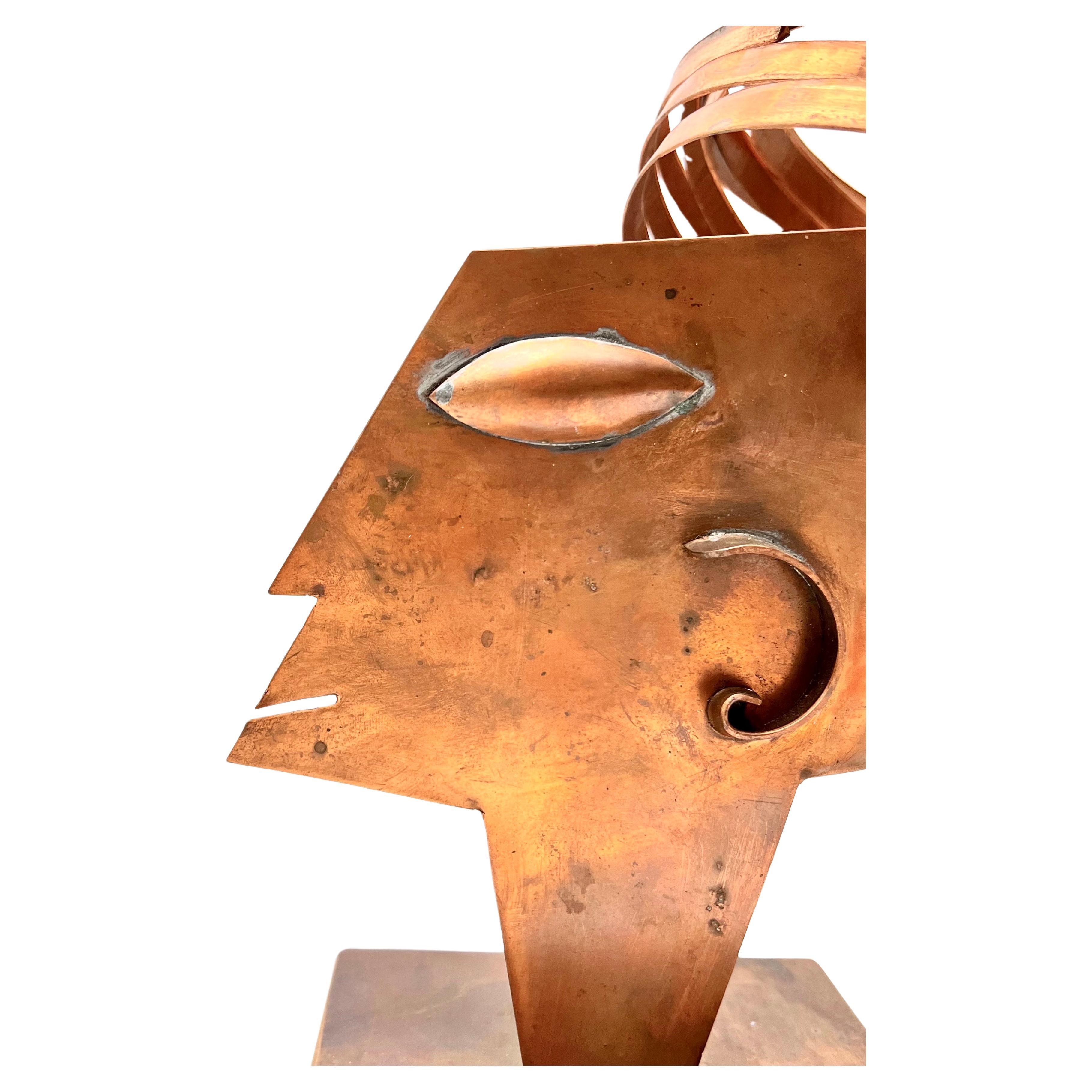 A fun and whimsical copper sculpture of a woman in the style of Hagenauer.  This mid size sculpture packs a big punch with her art deco elements and cascading hair.  Great shelf, desk, coffee or console table art.  Unsigned but slight visibility of