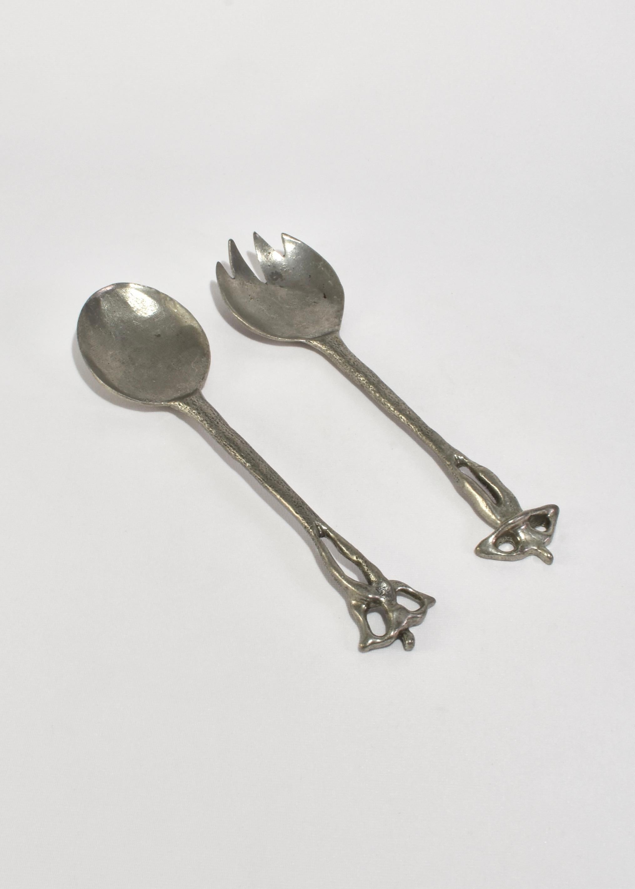 Rare pewter serving set featuring abstract figures as handles. Stamped Patrick Meyer.