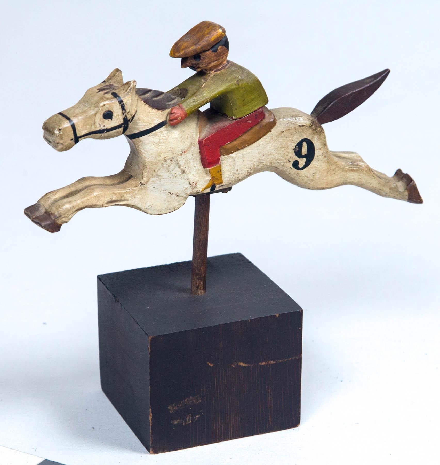 Figural Steeplechase horse and rider, early 20th century. Hand-carved and painted. Probably from a carnival game. A wonderful piece of Folk Art.