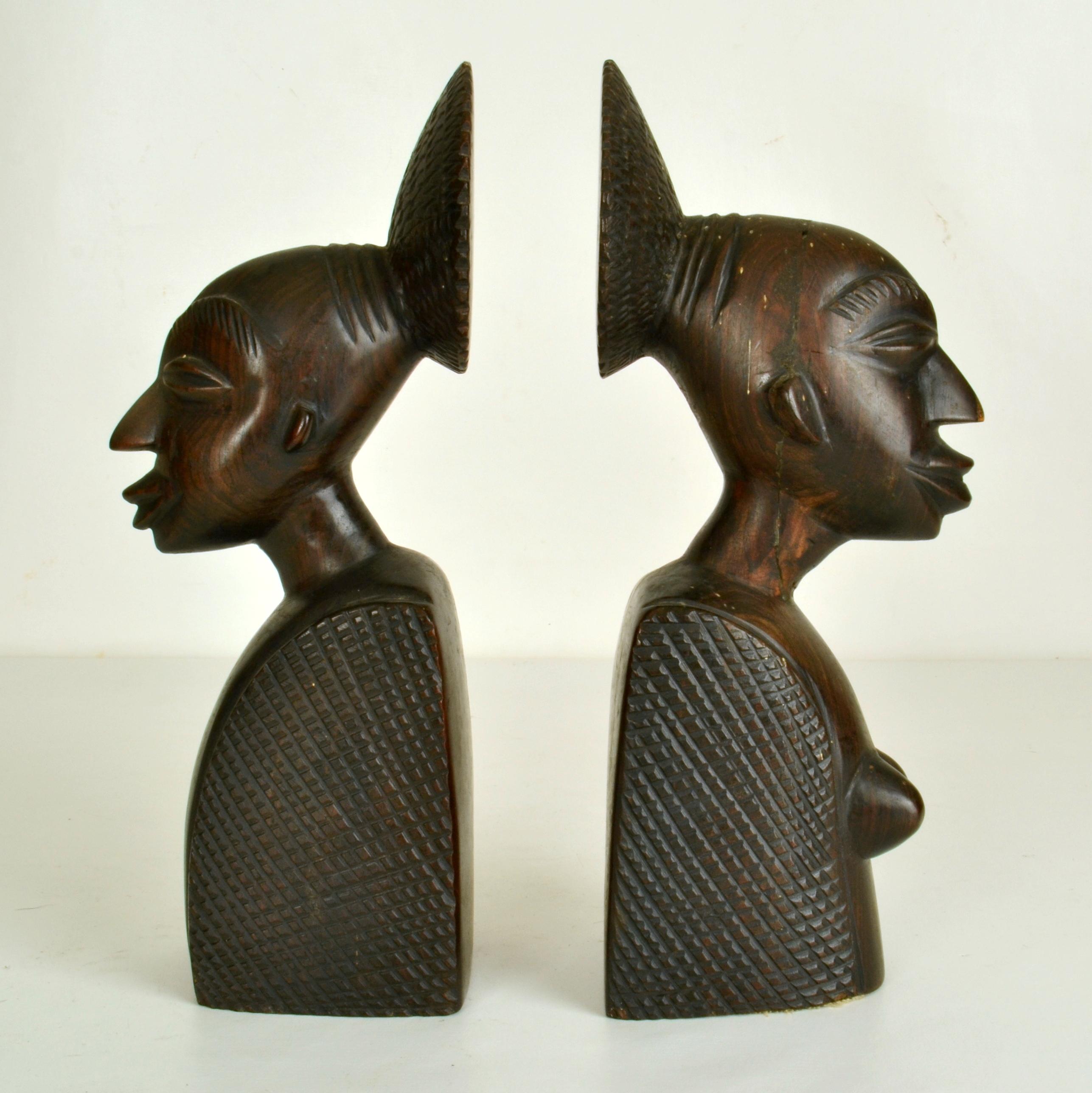 Figurative bookends hand carved from hardwood circa African West-coast 1950's depicting a man and women.

 