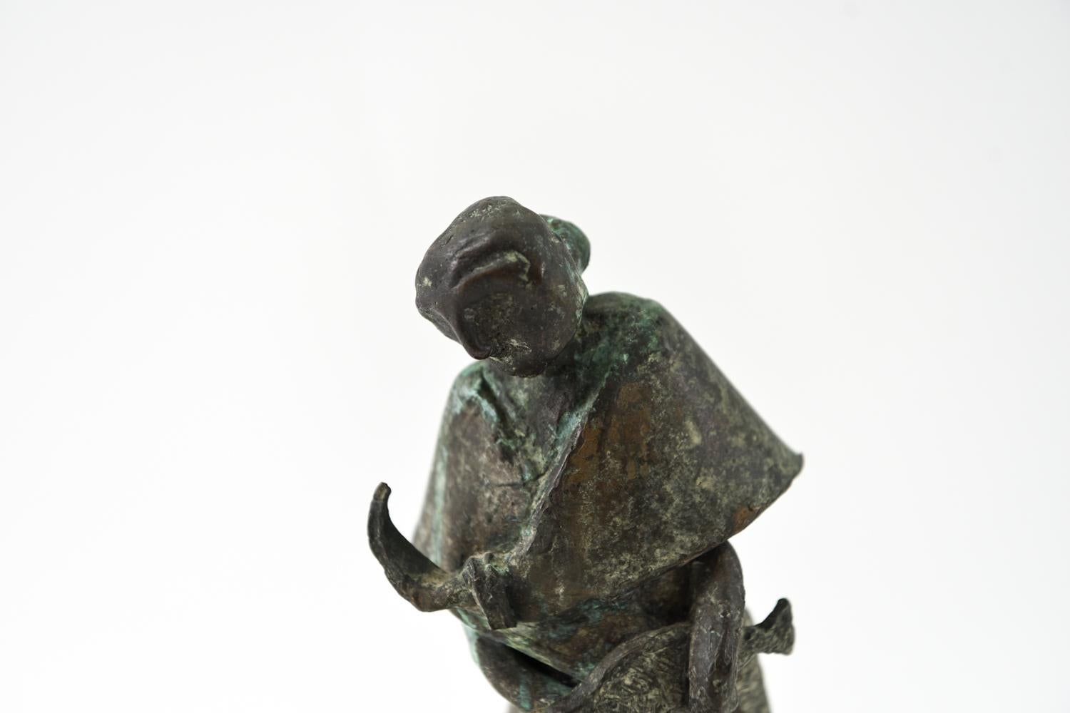 This expressive tabletop bronze portrays a female fishmonger at work. Apparently unsigned.