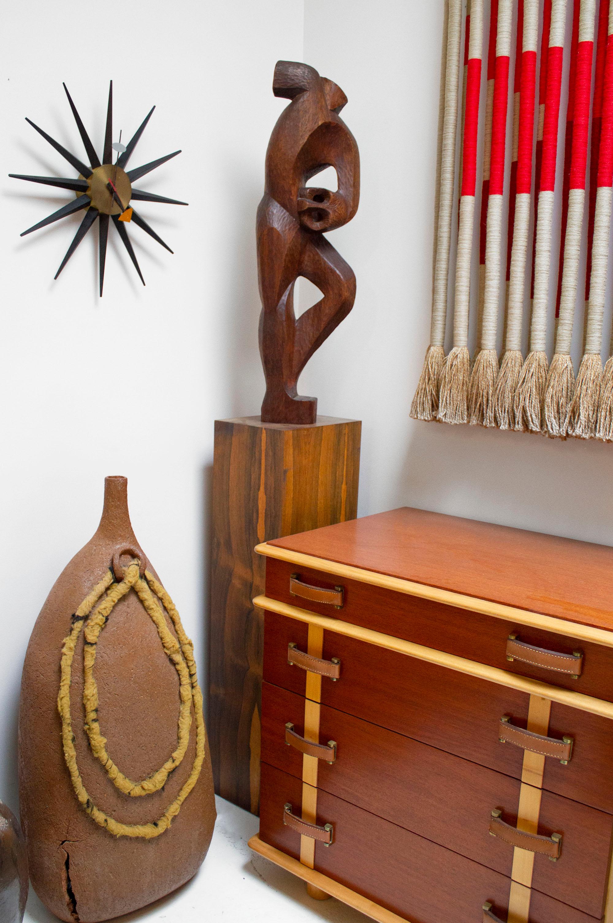 Figurative modernist hand-carved mahogany sculpture purchased in Brazil in the 1950s. Signed to the bottom rear edge. Brazilian rosewood plinth base included. The plinth can be refinished at the buyer's request.

Sculpture measures: 35.5