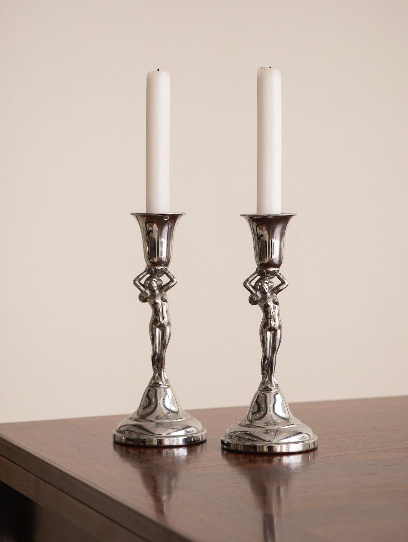 A pair of mid-century figural nude candlesticks. Marked “Krome Kraft Farber Bros.”
