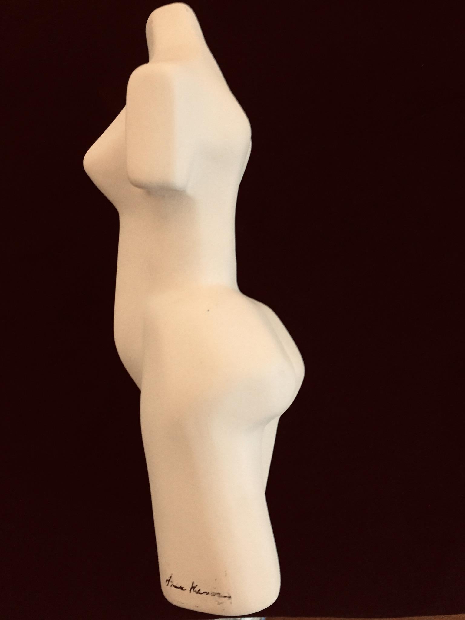 Figurative unglazed ceramic female sculpture. The natural color of the clay, paired with the robust physique is what called us to this piece. Signed at right as she faces the viewer, but we cannot determine the artist’s name. There are small, yet