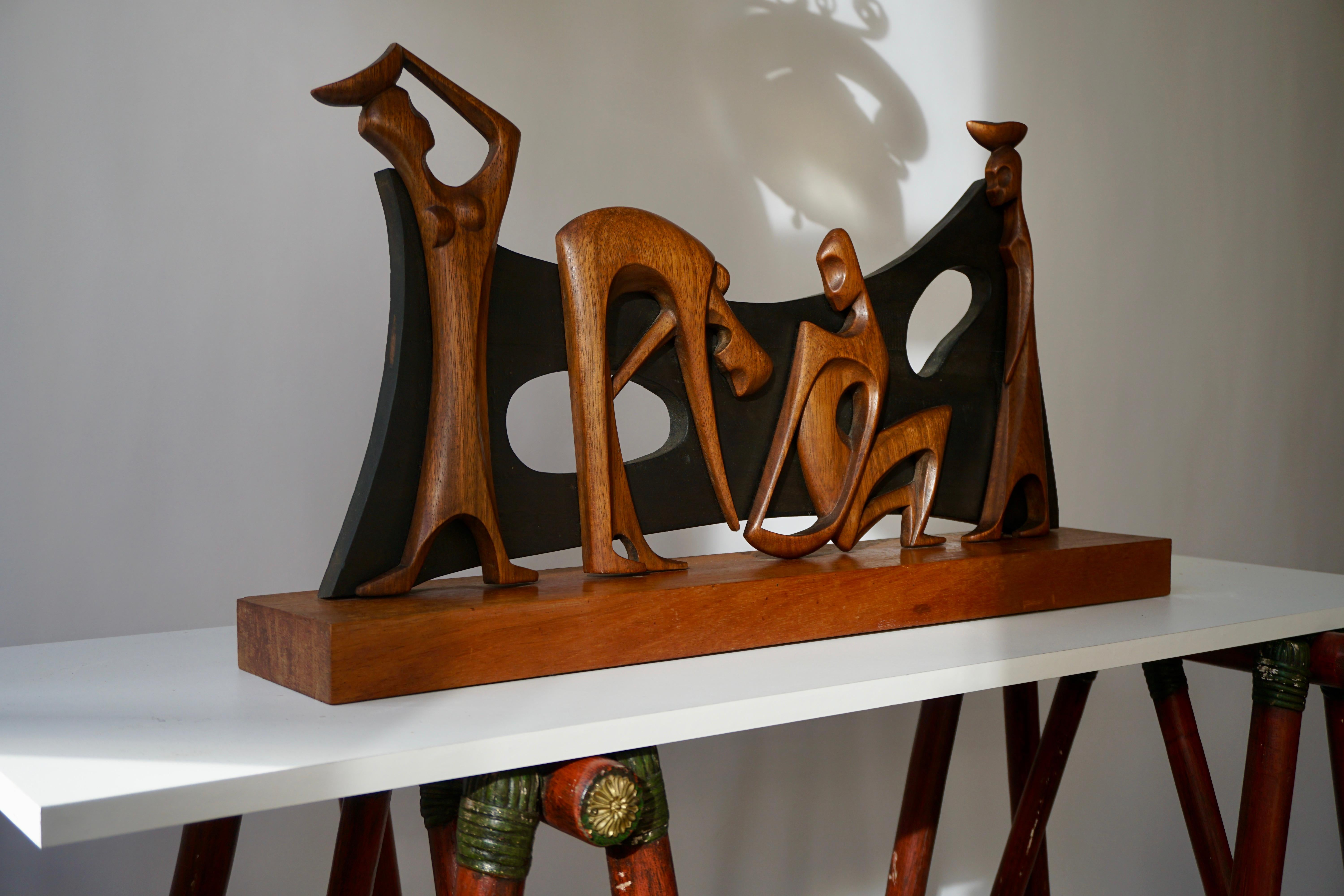 Highly rare and decorative elegant scene in wood of a man making respectfully advances to a lady, with female servants bringing food. Made in Congo in the 20th century, and offered by the Belgium Government to the City of Brasilia, at its