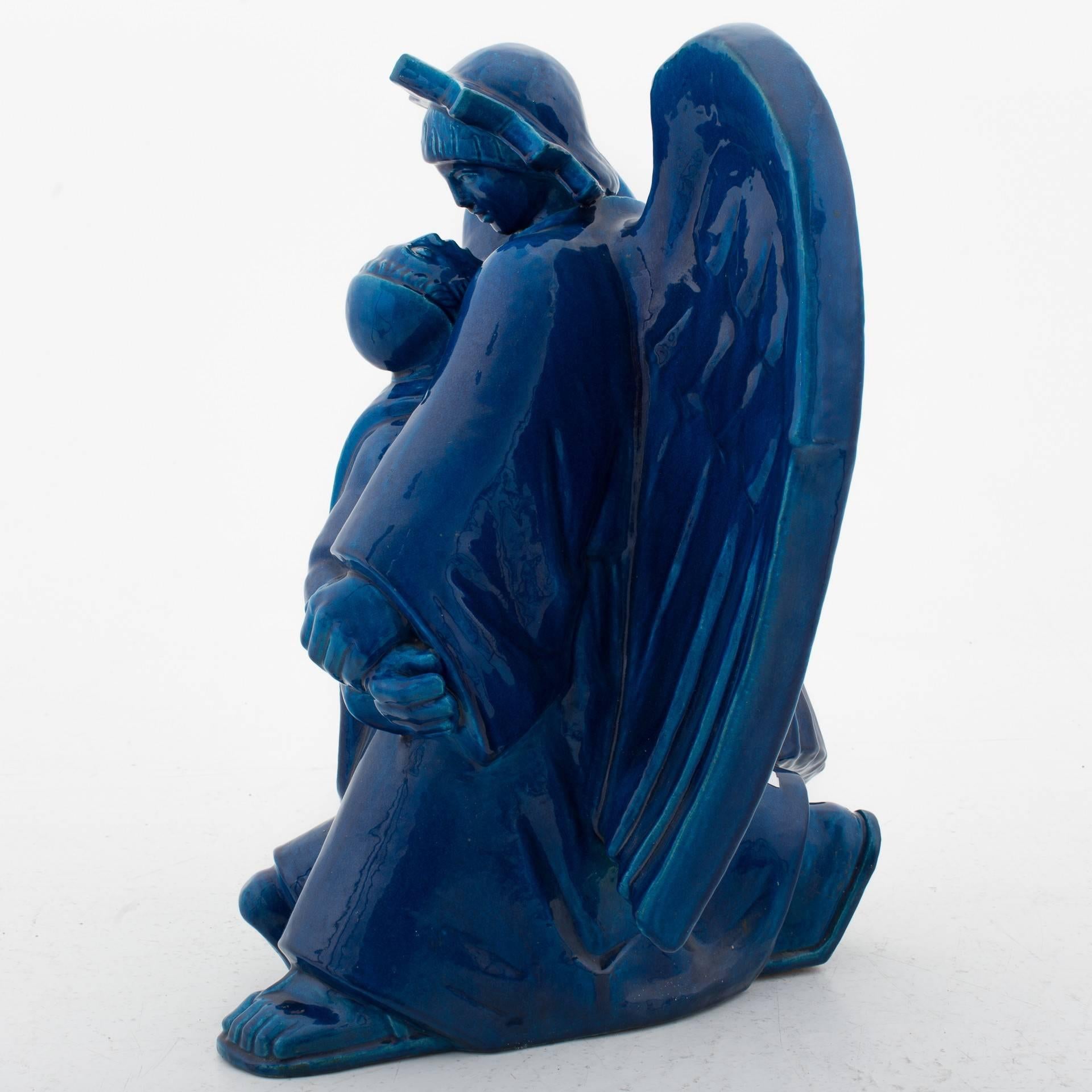 Religious figure in blue-stained stoneware. 