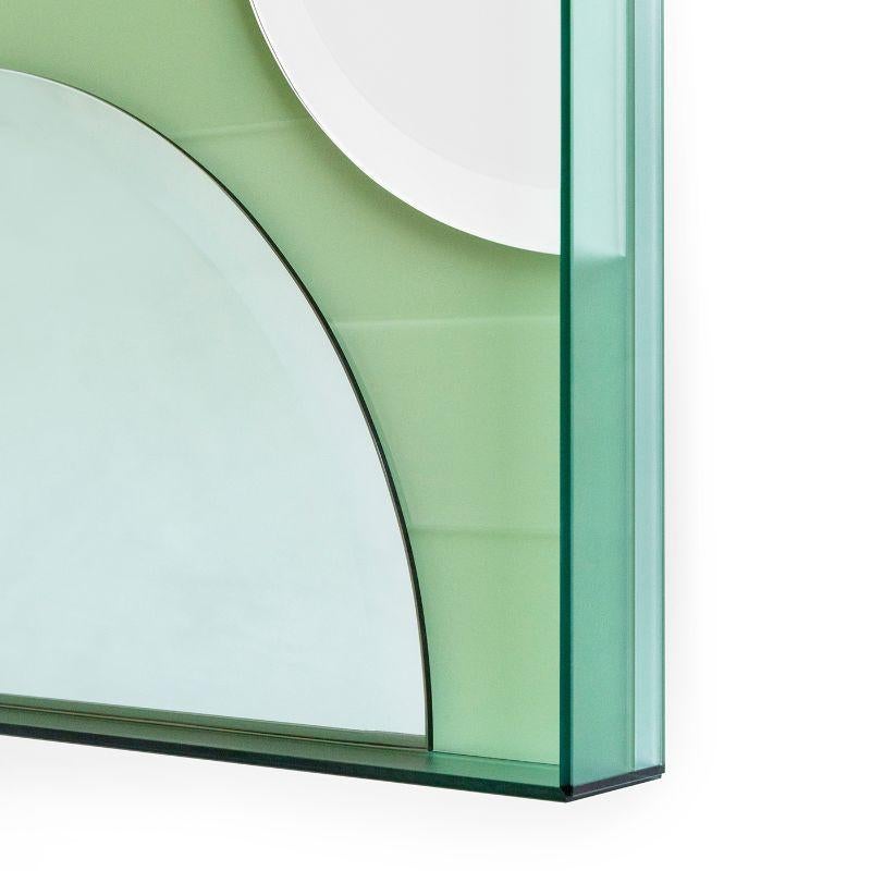 This wall mirror juxtaposes matte, glossy and coloured reflective glass in an artful arrangement to create an unconventional, striking accessory that is as much a work of art as a mirror.
 
