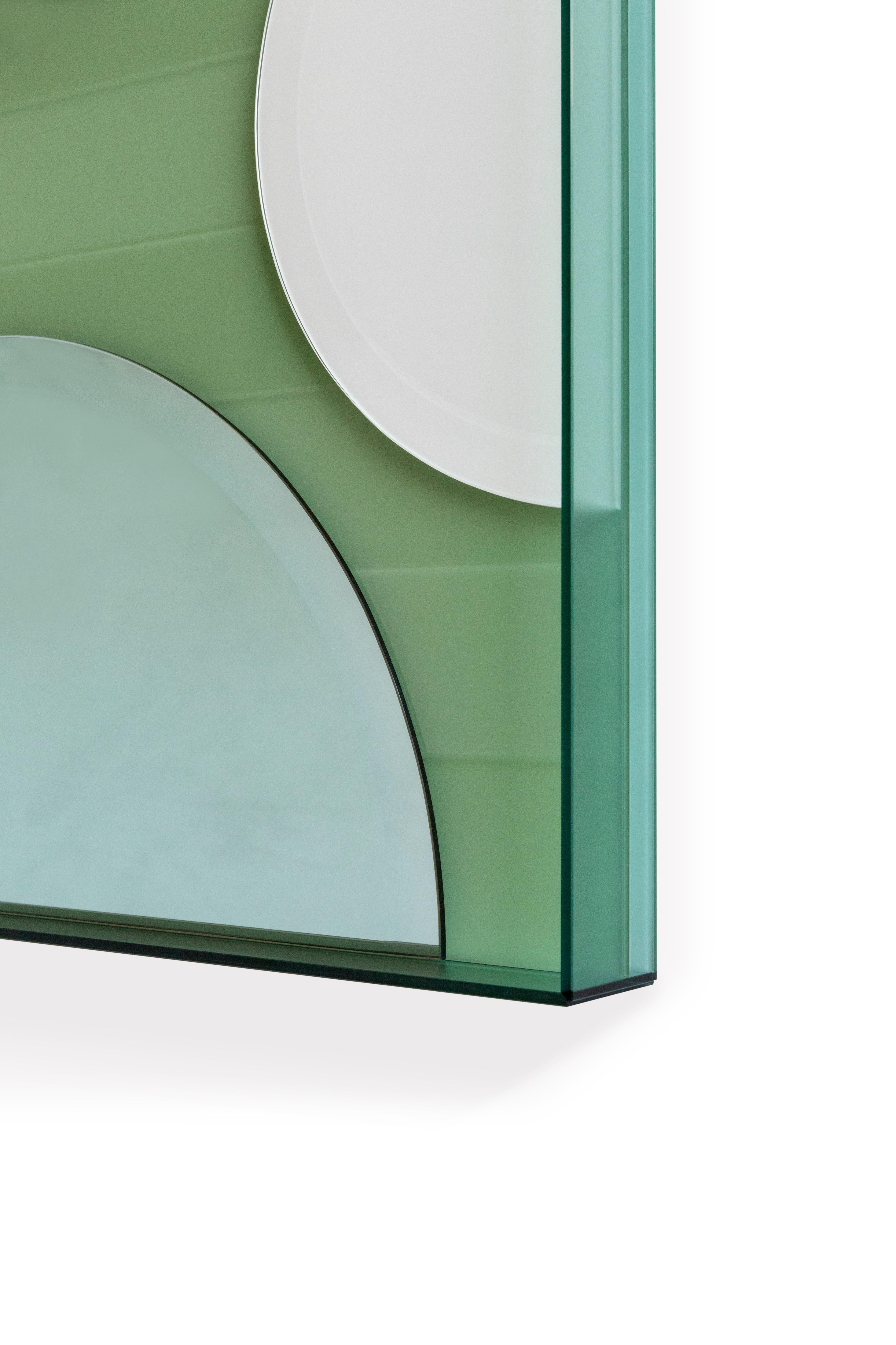 This wall mirror juxtaposes matte, glossy and coloured reflective glass in an artful arrangement to create an unconventional, striking accessory that is as much a work of art as a mirror.