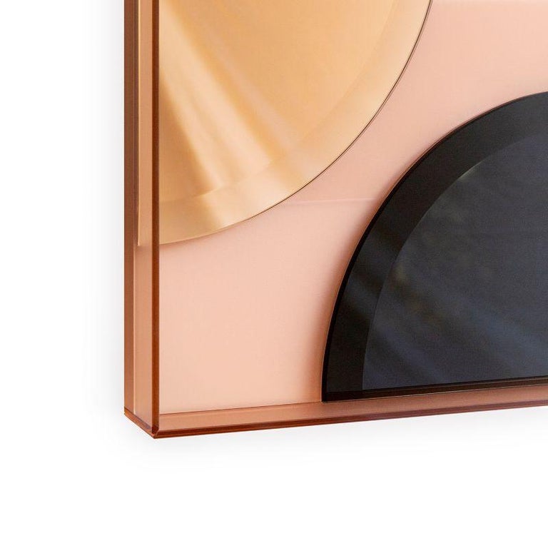 This wall mirror juxtaposes matte, glossy and coloured reflective glass in an artful arrangement to create an unconventional, striking accessory that is as much a work of art as a mirror.
