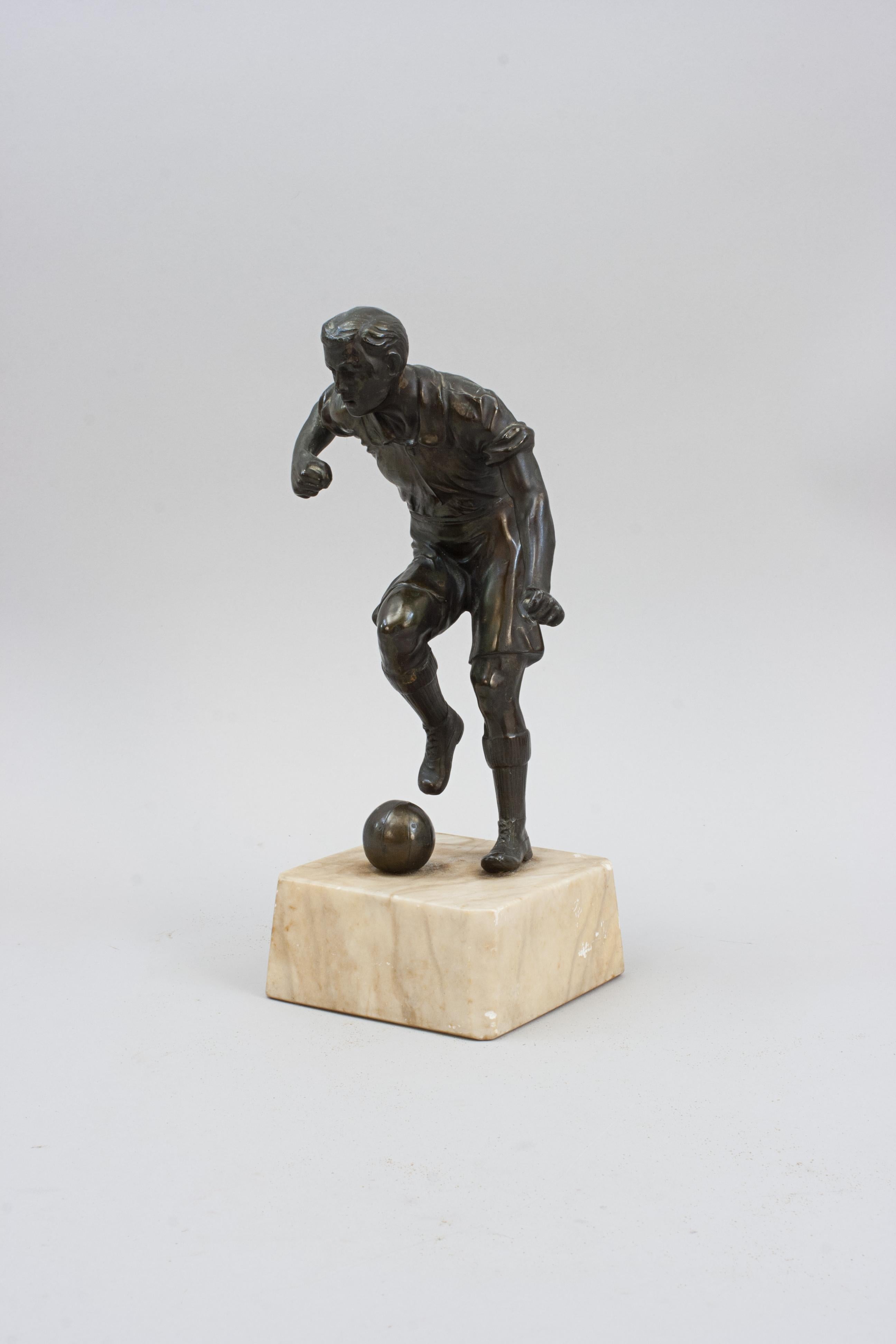 Antique Bronzed Spelter Football Figure.
A very nice Edwardian spelter figure of a footballer about to kick a football with his right foot. The figure has a bronzed finish and is mounted on a marble base.

Spelter is a white metal alloy cast in the