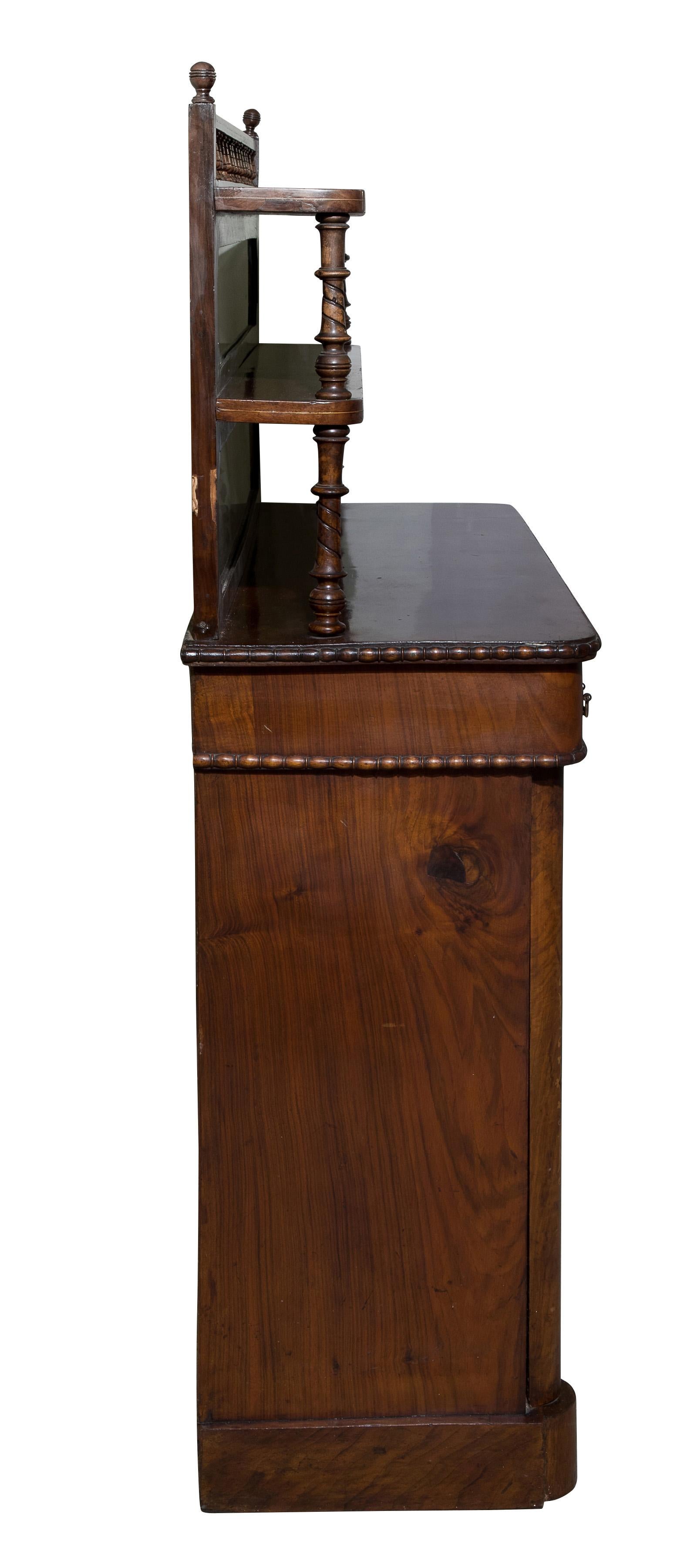 Figured and inlaid walnut chiffonier with; two shelves above two drawers and two cupboard doors below. 

circa 1870.