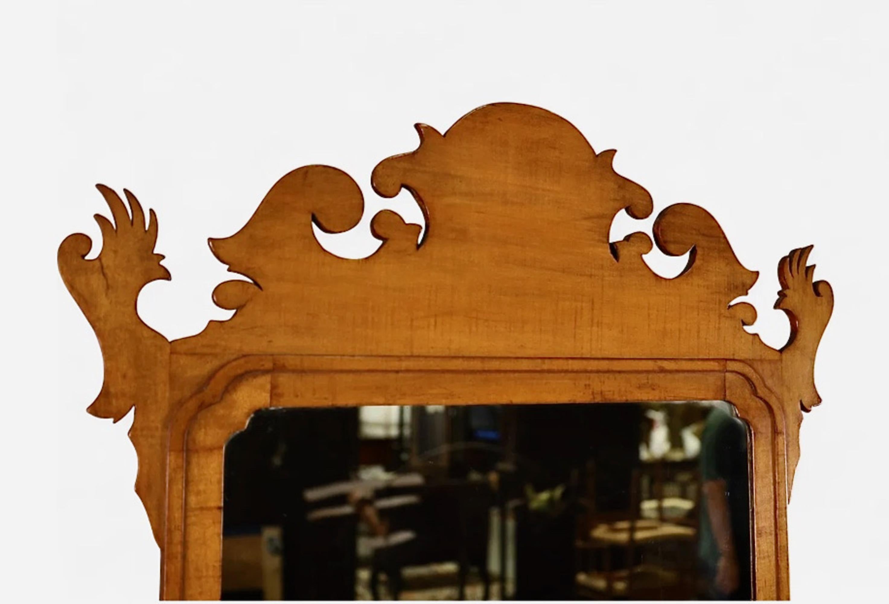 This is a classic and very good American Chippendale Mirror in figured Maple and Maple.  The back of the mirror is as interesting and the front is beautiful. The rough hewn board are attached with all of their original square cut and forged nails.