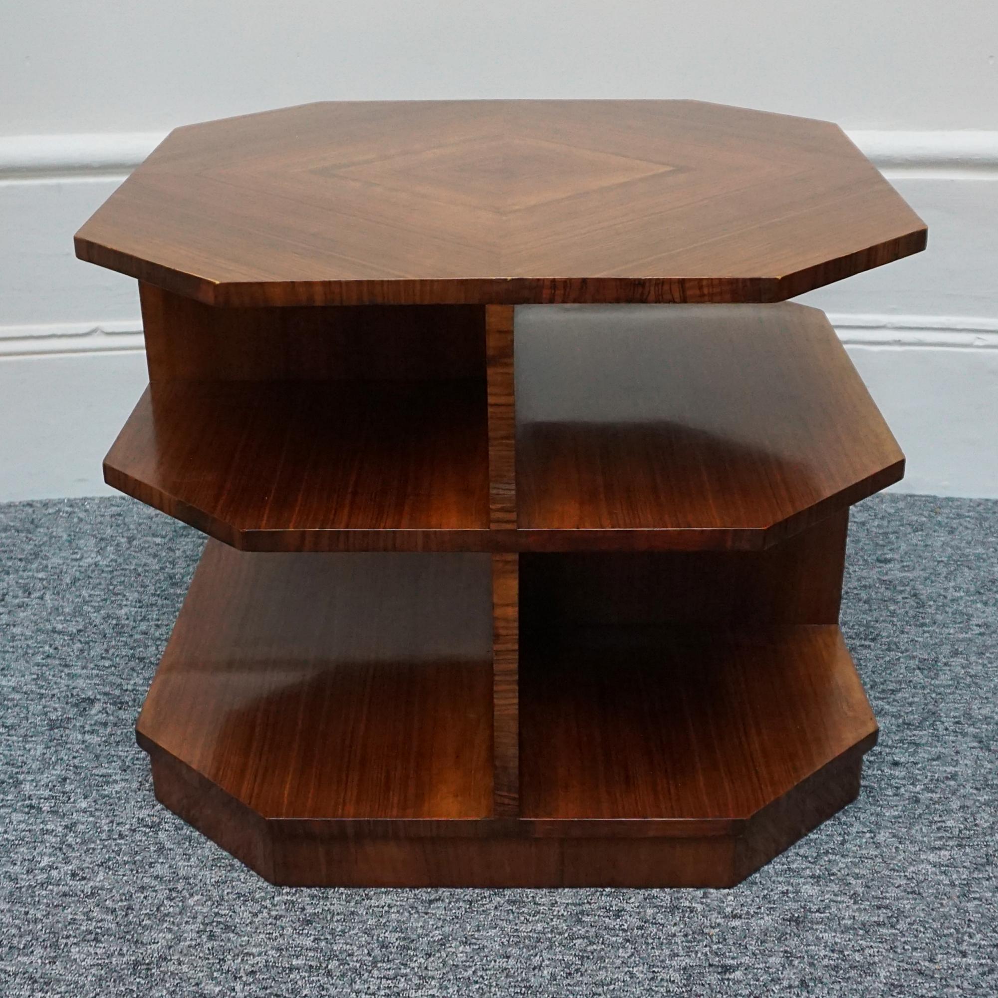 An Art Deco octagonal three-tier library table. Cross banded figured walnut veneer throughout with dividing sections to each tier. 

Dimensions: H 51.5cm W 63cm D 63cm 

Origin: English

Date: Circa 1930

Item Number: 2611232

All of our furniture