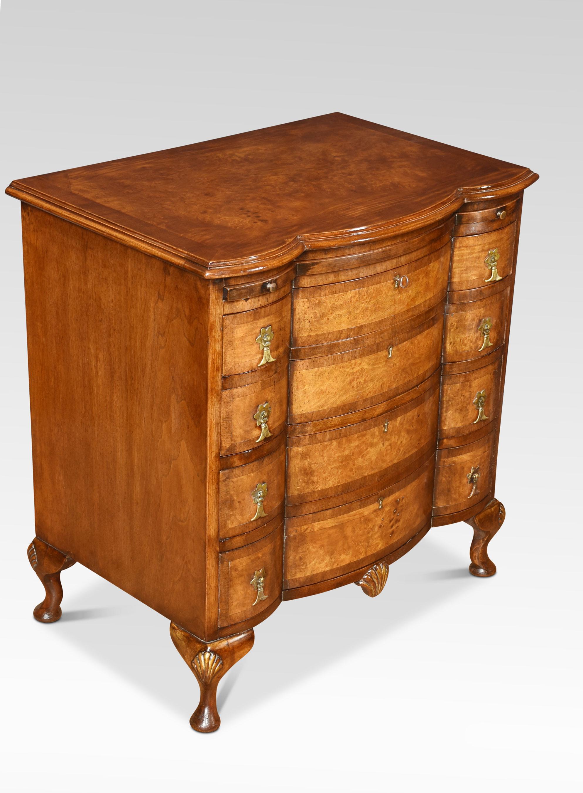 Figured walnut chest of drawers of small proportions The serpentine fronted top with moulded edge above brush in slide, and four long drawers fitted with brass drop handles. All raised up on shell caped cabriole legs.
Dimensions
Height 29