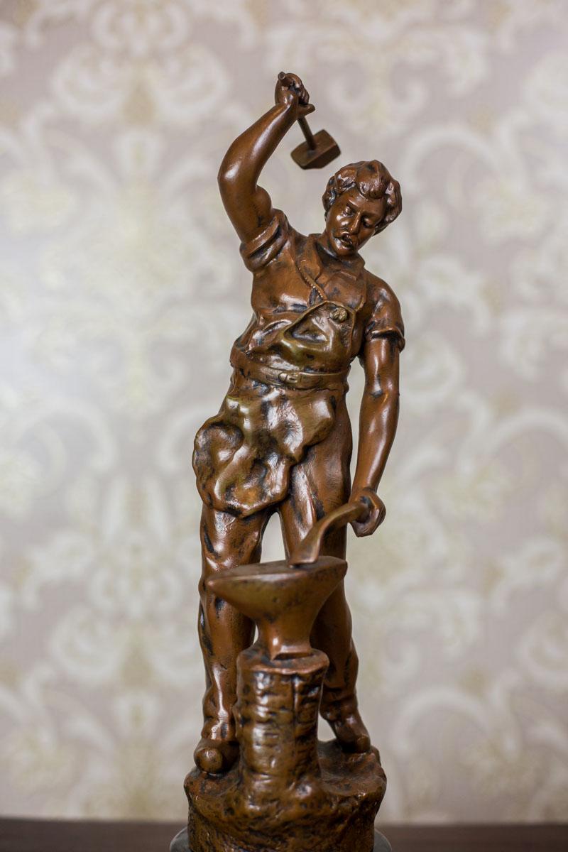 We present you a big figurine of bronzed Zamak depicting a blacksmith. This piece of art is based on a draft by Auguste Moreau (casting workshop unknown).
The figurine was created in the 1930s.

The item is in very good condition.