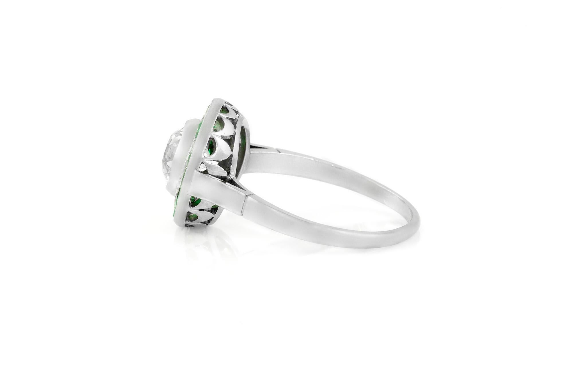 The ring is finely crafted in platinum with diamonds weighing approximately total of 1.50 carat and emerald.
