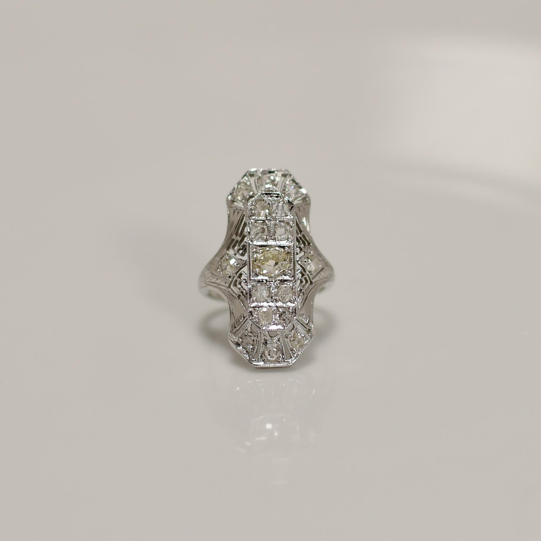 Elevate your jewelry collection with the timeless beauty of this Filigree Art Deco 18K White Gold Shield Ring, featuring a captivating Fancy Light Yellow Diamond in an Old Mine cut. The intricate filigree work on the white gold setting adds a touch