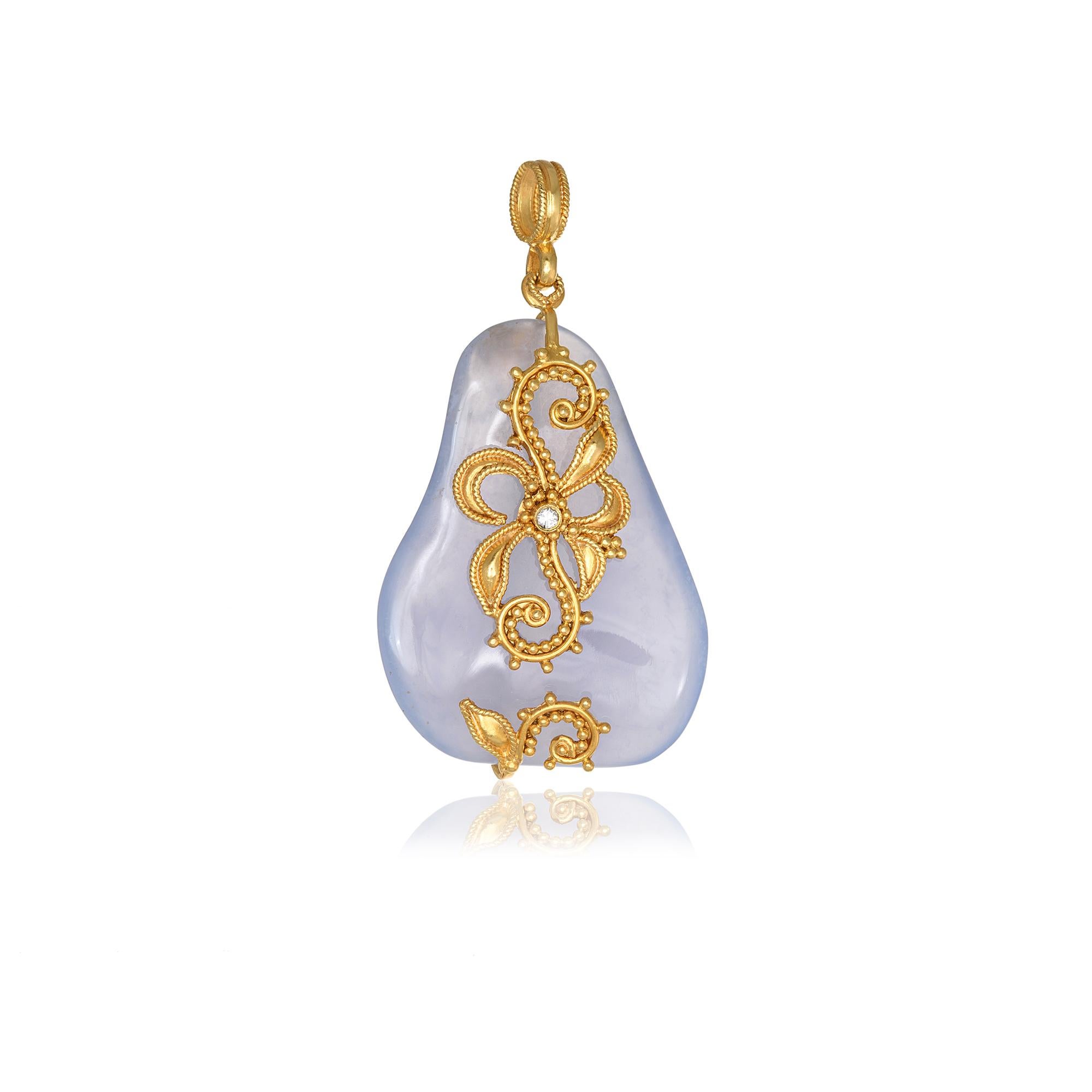 Pale Blue Chalcedony pendant handcrafted in 22Kt yellow gold with a brilliant cut diamond and gold flowers. This breathtaking jewelry piece is braided according to traditional techniques. The delicate and intricate wire ornamentation of Filigree and