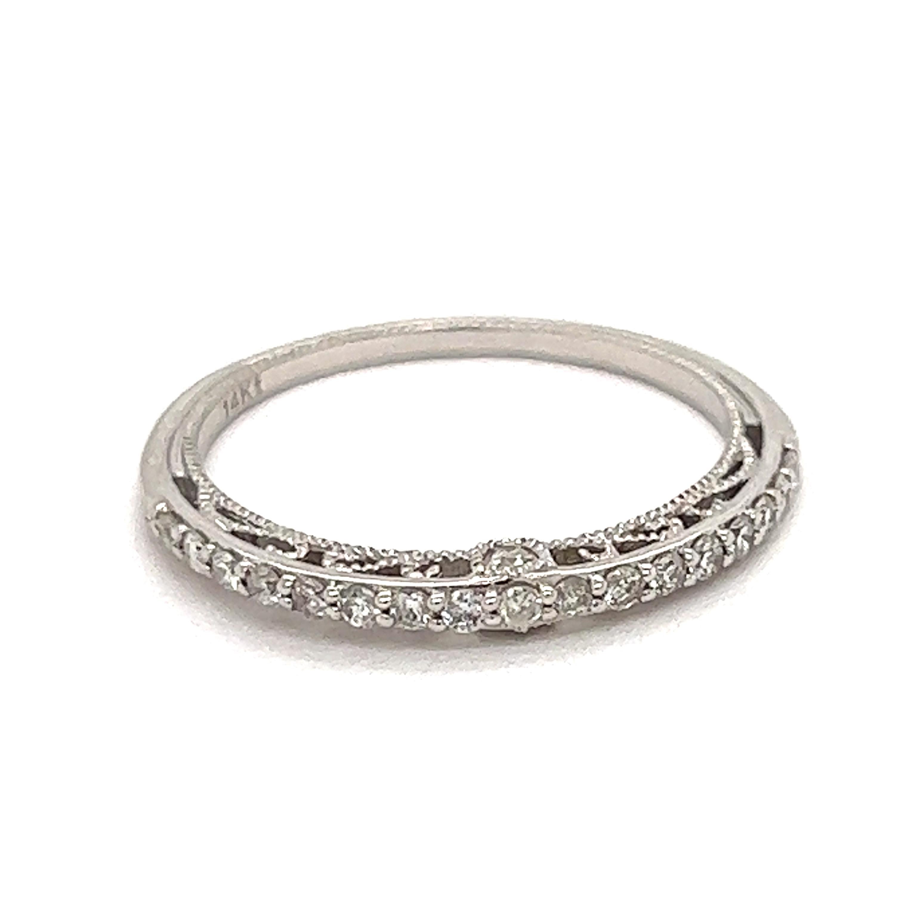 This delicate diamond band is intricately designed with beautiful filigree and milgrain finish.  With .25 cttw in SI clarity, G-H color diamonds and 1.85 grams of 14 Kt white gold.  Perfect to wear as a wedding band, or stack. 

This ring is sold as