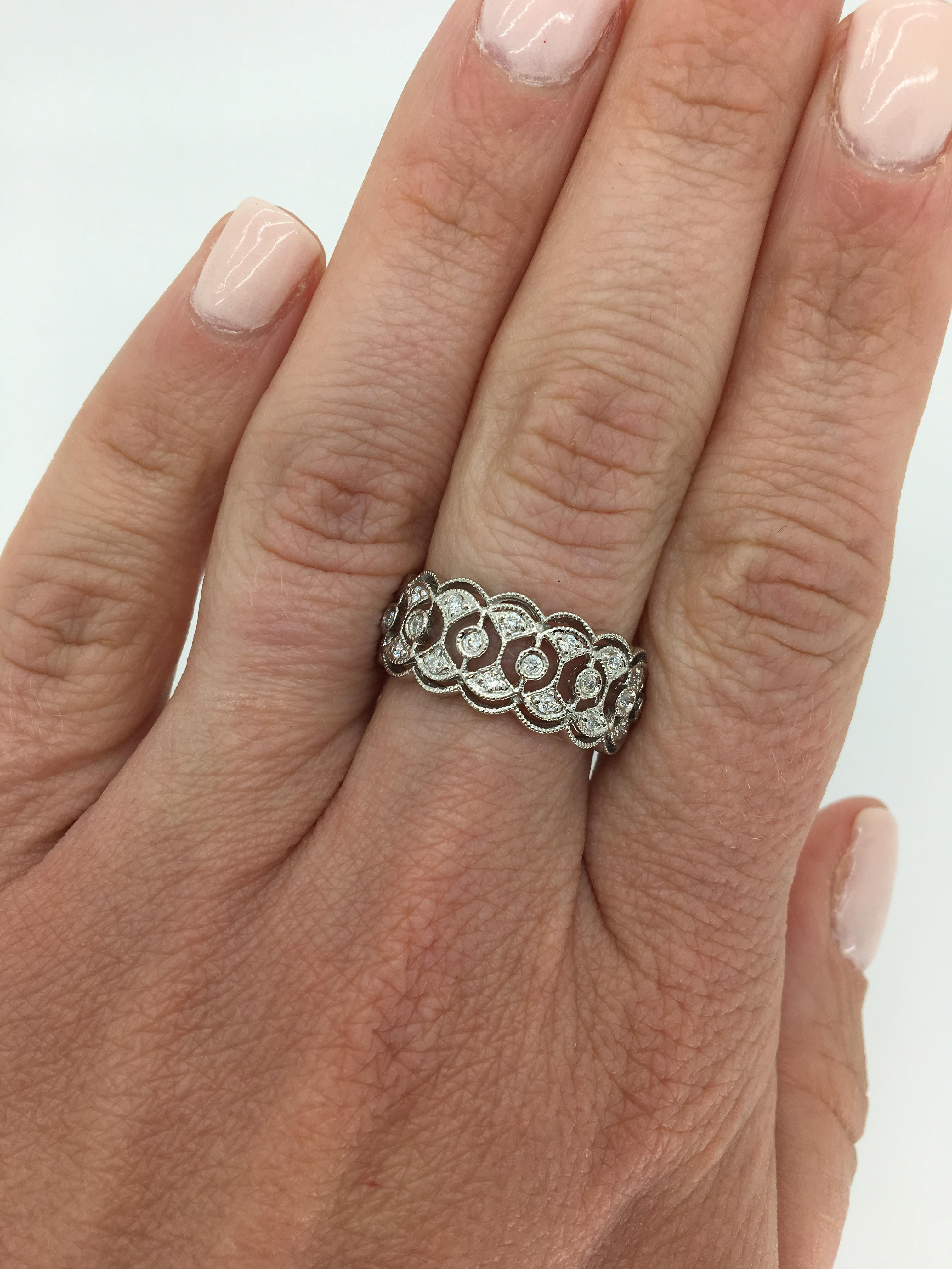Filigree detailed diamond band style ring crafted in 14k white gold.

Diamond Carat Weight: Approximately .33CTW
Diamond Cut: Round Brilliant Cut
Color: Average  G-I
Clarity: Average I
Metal: 14K White Gold
Marked/Tested: Stamped “14K
