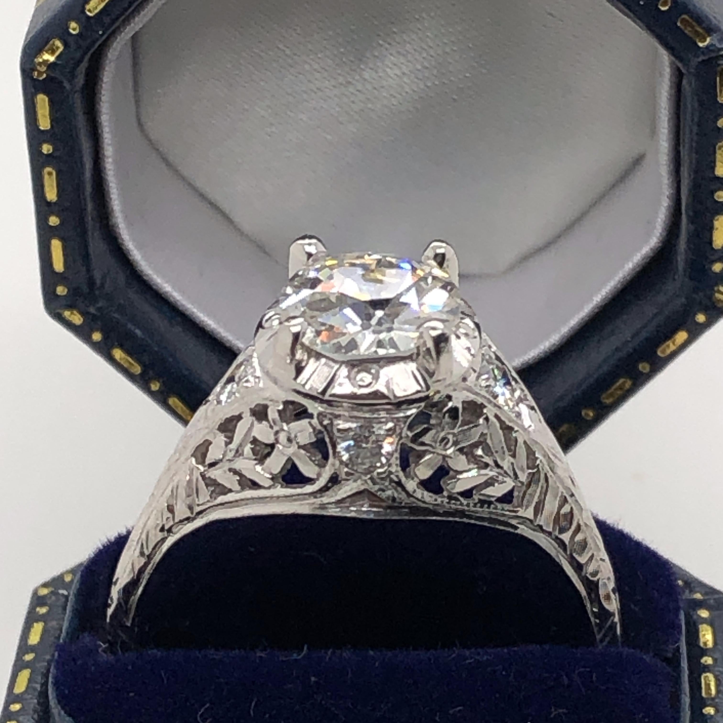 One 14 karat gold (stamped 14K) estate filigree engagement ring set with one Old European cut diamond, 1.32 carat total weight with M color and VS2 clarity. Finger size 7.  
