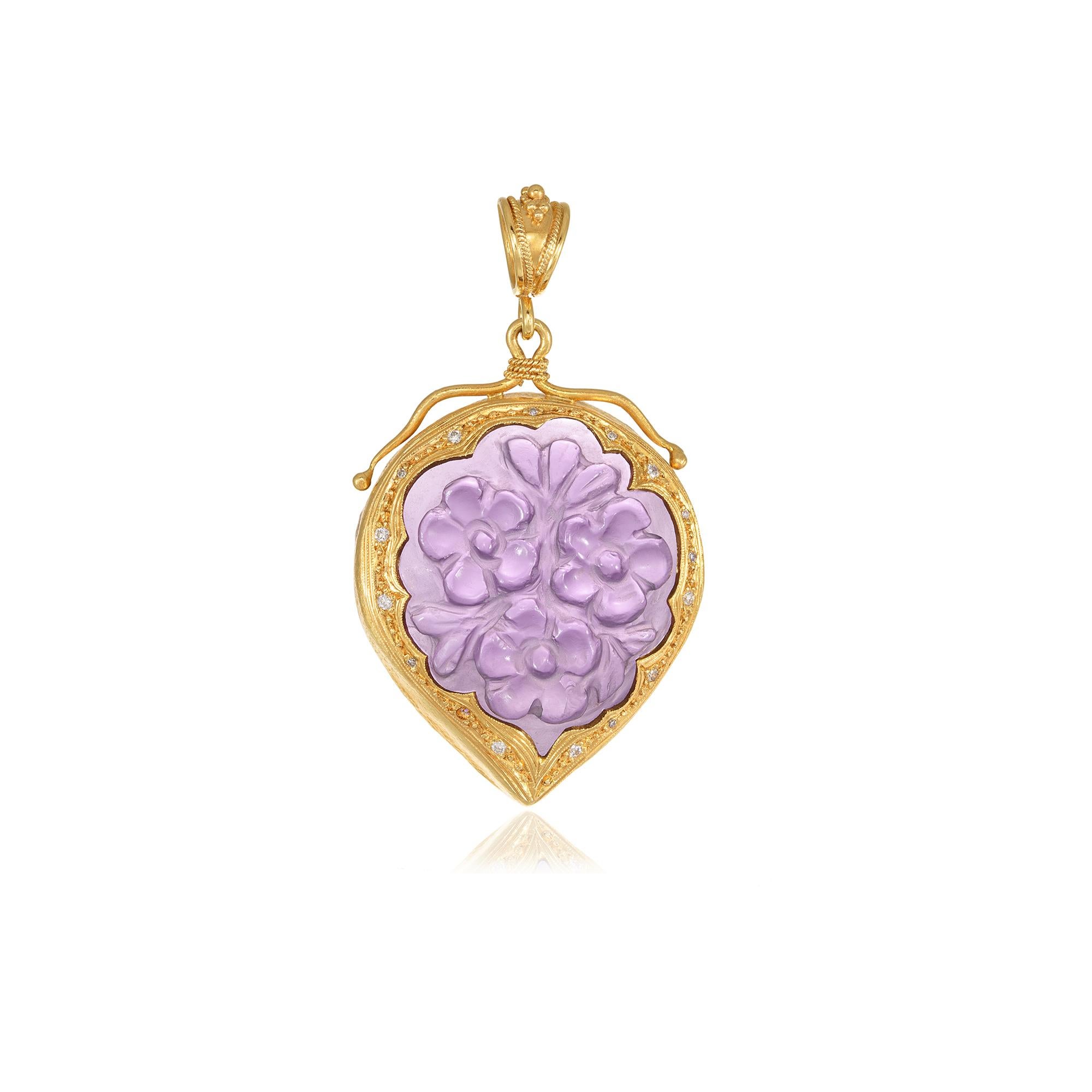 Drop shape filigree flower pendant handcrafted in 22Kt yellow gold featuring hand Carved Amethyst and brilliant cut Diamonds. Carved flowers, fine and simple, decorate the Amethyst in the heart of this chic pendant while some filigree details around