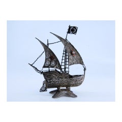 Filigree silver caravel with enameled crosses on scalloped base