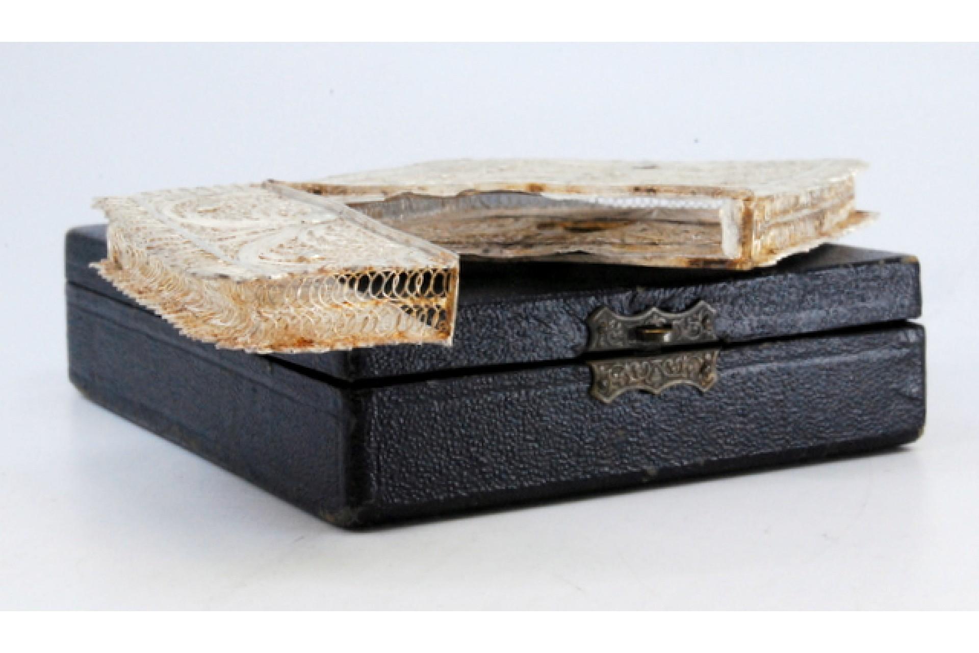 Description: Filigree silver card case with central monogram card and hinged lid. Metal: Silver. Origin: Portuguese. Brand: javali II Title. Weight: 50.01 grams. Dimensions: 10.5x7.4cm. Content: 833/1000. Assay Mark: Yes, between 1887 and 1937.