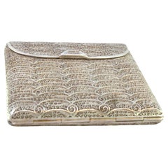 Filigree silver cigarette case with spring and hinged lid