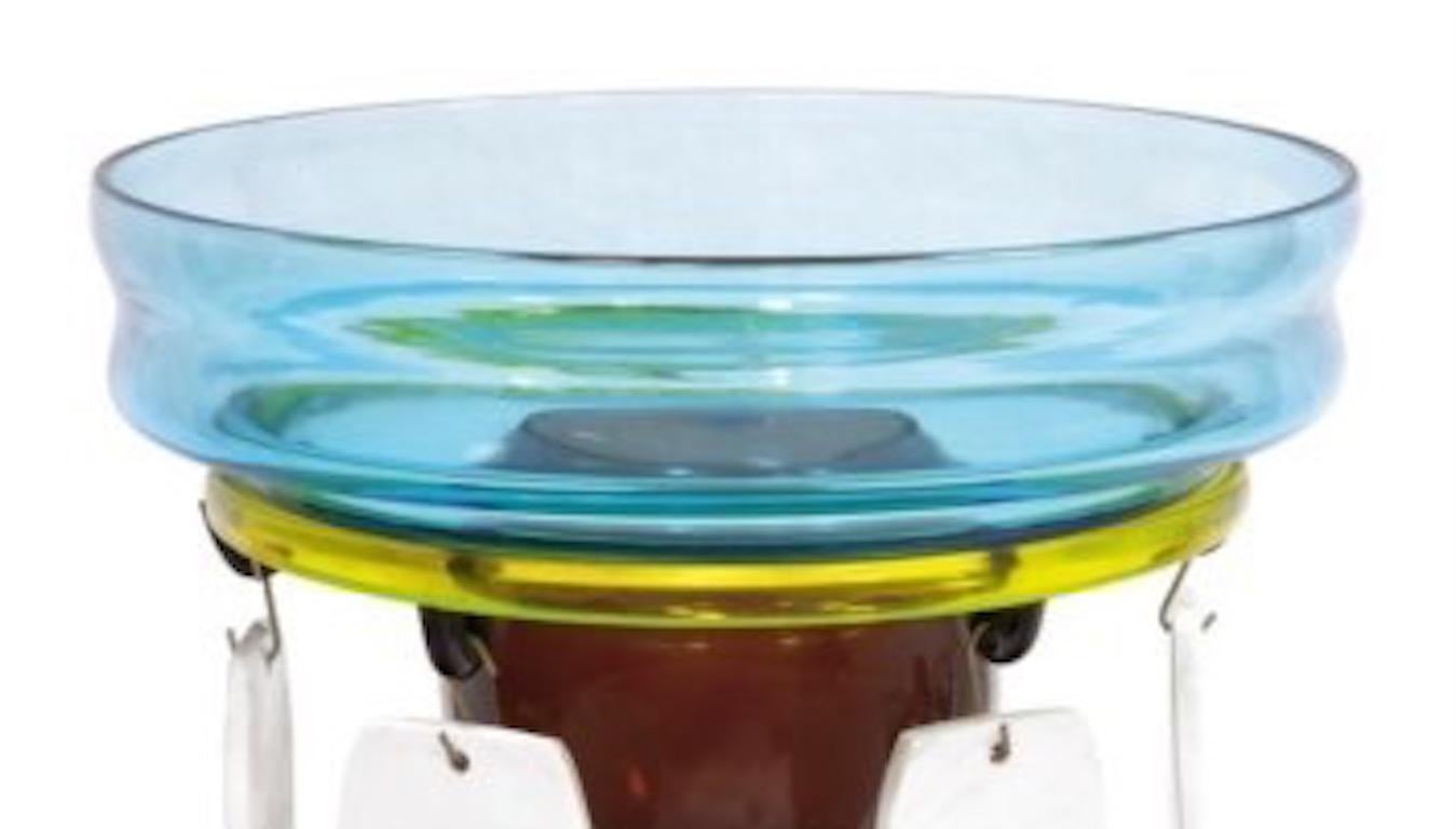 The Fililla glass vase is blown glass, with a pendant and was originally designed by Ettore Sottsass in 1986. Signed on the base, for further information please see authenticity info below.

Memphis Milano is the great cultural phenomenon of the